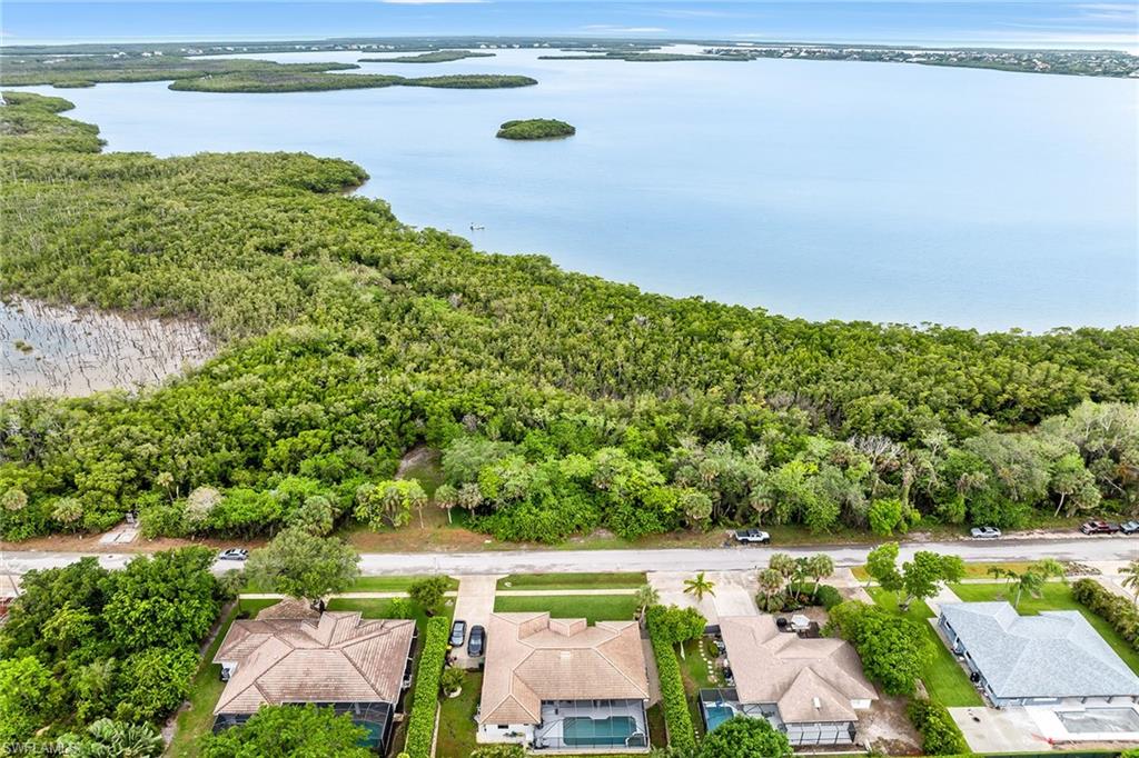 Discover a rare opportunity to build your custom home on one of Marco Island’s desirable home sites. On a high and dry quarter-acre lot with no HOA restrictions, this 100-by-110-foot property offers exceptional flexibility in a prime island location. Surrounded by lush preserve and featuring sweeping views of Barfield Bay, the setting delivers privacy and a tranquil natural backdrop, with adjoining preserve owned by Collier County, ensuring it can never be developed and preserving the natural setting indefinitely. Filled and ready for construction, the lot provides the ideal canvas for a custom coastal retreat just minutes from Marco Island’s celebrated beaches, shopping, dining and recreation. Ownership includes access to the exclusive Residents’ Beach, offering pristine white sand, breathtaking sunsets, beachfront dining and relaxed tiki-style lounging. This is more than a homesite, it’s the opportunity to create a lifestyle in one of Florida’s sought-after coastal communities.
