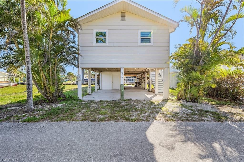 Welcome to 16210 Antigua Way, Bokeelia, FL 33922, where affordable waterfront living meets ultimate convenience. This charming 2-bedroom, 1-bathroom home is perfectly positioned on a quiet dead-end street, offering direct sailboat access to the Gulf—no bridges to navigate! Enjoy a short boat ride to Charlotte Harbor, Boca Grande Pass, and breathtaking outer island beaches. Start your mornings with stunning sunrises from a large screened porch. Additional features include an 8,000-pound boat lift, covered parking, ample storage, and a spacious workshop. This is coastal living at its finest—don’t miss out! The lot next to this home is for sale 16220 Antigua Way mls# 2025009263
