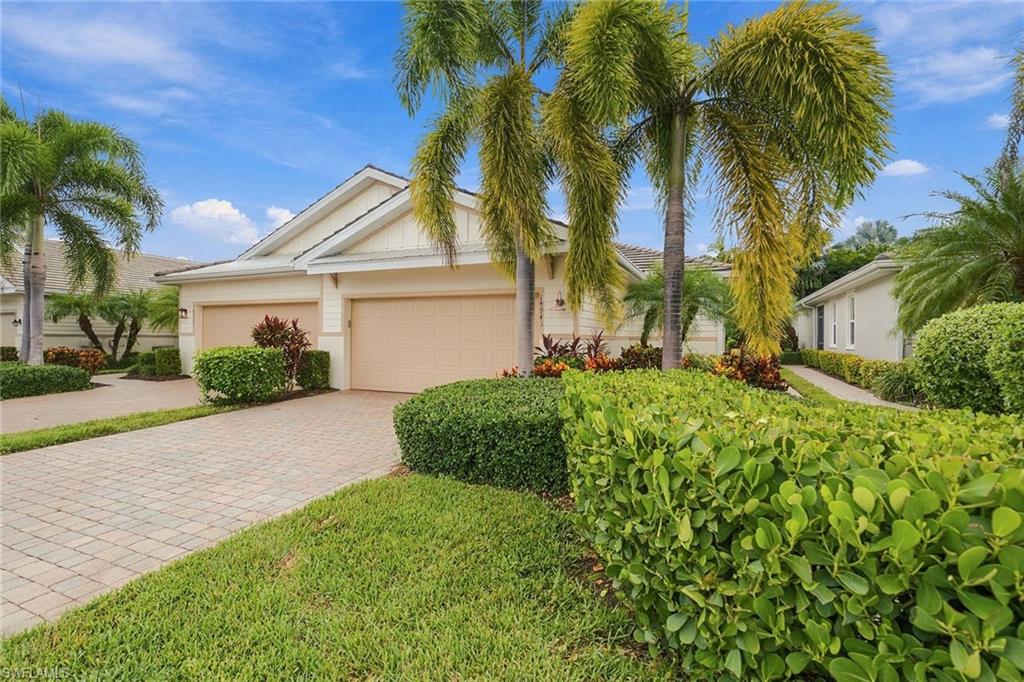 One or more photo(s) has been virtually staged, AI generated or rendered.  Located in the sought-after Naples Reserve community, this freshly painted residence offers a desirable combination of comfortable living, flexible space, and an extended lanai with western exposure for sunset views. Featuring two bedrooms, two full baths, a versatile den, and a two-car garage with a lockable storage closet, the thoughtfully designed floor plan provides inviting spaces for everyday living and entertaining, with room to personalize the outdoor setting to suit your lifestyle. Inside, abundant natural light enhances the freshly painted interiors, while tile flooring throughout the main living areas and carpeting in the bedrooms create a practical balance of style and comfort. Recessed lighting adds a clean, contemporary touch. The kitchen features stainless steel appliances, quartz countertops, a tile backsplash, and a central island that offers additional workspace and a natural gathering point. A breakfast bar provides casual seating, while the open dining and living areas create an easy flow for hosting family and friends. Sliding glass doors extend the living space onto the expanded lanai, creating an inviting setting for outdoor relaxation and dining. The western exposure provides the opportunity to enjoy colorful evening skies as the sun sets. The yard also offers room for a future pool, allowing buyers to envision an outdoor retreat tailored to their preferences. Manual shutters provide storm protection, while a newly installed whole-home water filtration system offers an additional upgrade for everyday comfort and convenience. The primary suite features his-and-hers walk-in closets and custom mirrors, while the en-suite bathroom is appointed with dual sinks and a spacious glass-enclosed shower. A second bedroom and full bathroom accommodate guests, and the separate den offers flexibility for a home office, reading room, or additional living space. Naples Reserve elevates the everyday with an impressive collection of resort-inspired amenities centered around a lakefront clubhouse. Residents enjoy a resort-style pool, fitness center, tennis and pickleball courts, bocce, basketball, and a tiki bar and café. Waterfront recreation includes access to a private beach, boat ramp, Kontiki Island, electric boats, paddleboards, and kayaks. Miles of walking and jogging paths, two dog parks, and a one-mile rowing lane further expand the opportunities for outdoor enjoyment. Combining a functional floor plan, an extended sunset-facing lanai, convenient lockable garage storage, and an extensive array of community amenities, this residence offers a relaxed Southwest Florida lifestyle with opportunities to enjoy both indoor comfort and outdoor recreation in Naples Reserve.