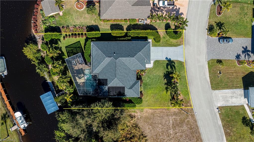 Welcome to your future GULF ACCESS HIDDEN GEM OF A home in the charming Riverbend Community. This home is built like a FORTRESS! NO FLOODING OR ANY WATER INTRUISION. This home sits on just under a 4 LOT SITE & BOAST 2544 sq ft of living space. Home is meticulously maintained & beautifully landscaped all around the home. 2 car garage with epoxy flooring and lots of storage & cabinets. The chef dream kitchen steals the show with the massive granite countertop, custom cabinetry, GAS STOVE, stainless steel appliances with a DOUBLE FRIDGE AND FREEZER, SEPERATE ICE MAKER THAT AUTOMATICALLY REPLACES ICE DAILY AND BEAUTIFUL BACKSPLASH & POT FILLER. The newly enclosed lanai has NEW IMPACT WINDOWS AND SLIDERS, and a separate 2-ton A/C. The primary bedroom and bath features tile flooring, beautiful crystal fan/light and tray ceilings and an extensive row of closets with cabinets. The Unique 1/ bath accessible from primary suite to family rooms serves as a convenient pool bath with separating it from the primary bathroom. There is a separate shower & soaking tub. Step outside to your private oasis featuring screened lanai with pavers solar heated pool enhanced with supplemental electric heat pump, delightful outdoor kitchen complete with a BBQ smoker, panoramic view from pool with large picture screen, enclosure that looks out to the canal, and cozy lounge area with swing under the pergola & gas fire pit. Great for entertaining guest and family. Boat dock area is a boater's dream with composite dock decking, 10lb boat lift & new canopy. Hurricane screens on the back lanai. This home also features an electric fireplace in the living area. This home is a must see. You will not be disappointed! SELLER WILL ENTERTAIN ALL REASONABLE OFFERS! PLEASE NOTE THAT BOATS 25' IN LENGHT CAN FIT THROUGH THE BRIDGE ON THE CANAL BUT THE TOP CANNOT BE FIXED. IT MUST HAVE ABILITY TO FOLD DOWN!