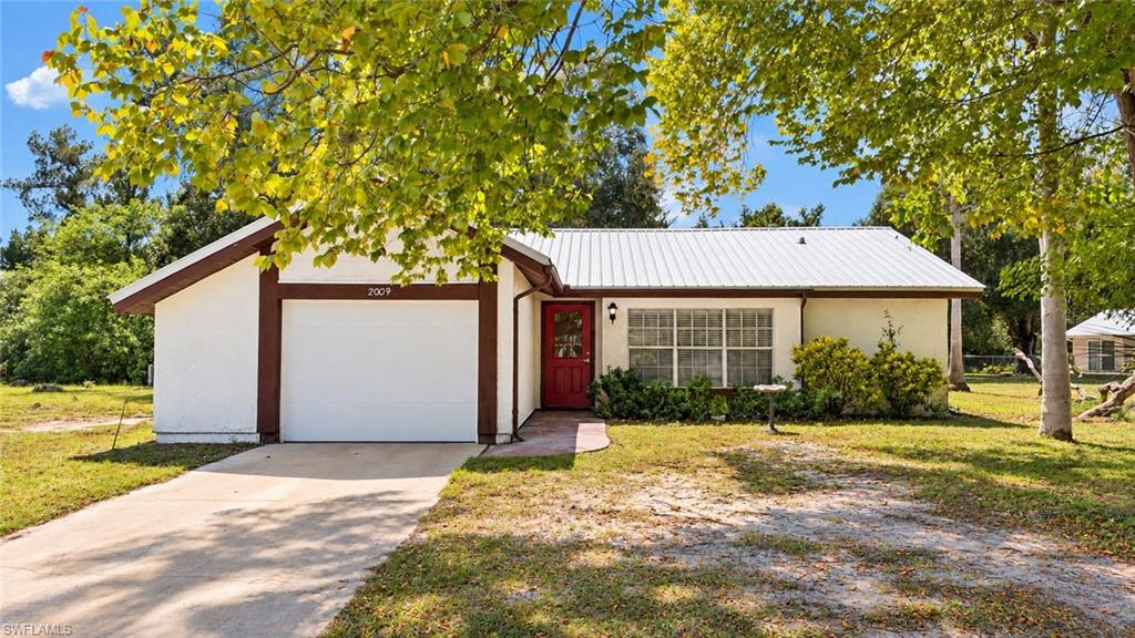 MOVE-IN READY and full of natural light! Welcome to 2009 Mariner Ct, a charming 2 bedroom, 2 bathroom home tucked away in the quiet Country Village community. Inside, you’ll find a desirable OPEN FLOOR PLAN, laminate flooring throughout the main living areas, carpet in the bedrooms, and volume ceilings that make the home feel open, and inviting. The functional kitchen features warm MODERN CABINETRY and flows easily into the dining area and main living space. The living area features double sliding glass doors leading to the oversized patio, while the spacious primary bedroom has its own set of double sliders to the patio, allowing tons of natural light to pour in throughout the home. Step outside and enjoy the oversized screened in lanai, perfect for relaxing and enjoying the Florida weather, along with a large backyard offering plenty of room to spread out! You're sure to appreciate the privacy that comes with the split floor plan. The primary bathroom includes a walk-in shower, while the guest bathroom offers a convenient shower/tub combination. ADDITIONAL FEATURES INCLUDE a metal roof installed in 2018 and the AC was installed in 2022 with a 10 year warranty, giving buyers added peace of mind for years to come! Country Village offers a true sense of community with a community clubhouse, swimming pool, and frequent resident-organized events, all with a LOW HOA of just $410 per year. Whether you’re looking for a full-time residence or seasonal Florida getaway, this home has it all... the only thing missing is YOU! *photos have been enhanced and virtually staged