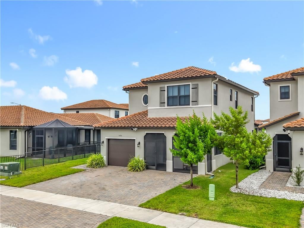 Welcome to this beautifully maintained Encinitas model, perfectly positioned on an oversized lakefront lot in Silverwood at Maple Ridge, within the award-winning community of Ave Maria. Offering more than 2,200 square feet of living space, this spacious 4-bedroom, 3.5-bath home with a versatile loft features the highly sought-after convenience of a first-floor primary suite. The light-filled, open-concept kitchen is designed for both everyday living and entertaining, featuring quartz countertops, white shaker-style cabinetry, a breakfast nook, generous prep space, and an oversized counter with sink overlooking the living and dining areas. Large windows draw your attention to the peaceful lake views beyond. Upstairs, you'll find three additional bedrooms, two full bathrooms, and a spacious loft that can easily serve as a second living area, home office, media room, or playroom. No carpet! Outdoor living is equally impressive, beginning with a charming screened front porch and continuing to the extended covered lanai with a permanent aluminum pan roof, providing a comfortable space to relax or entertain year-round. The fully fenced backyard and expansive side yard offer plenty of room for pets, a playset, gardening, or future outdoor enhancements while still enjoying the home's tranquil waterfront setting.
Residents of Maple Ridge enjoy access to The Club at Maple Ridge, a multimillion-dollar amenity center featuring a resort-style pool, fitness center, steam room, billiards and game rooms, party room, children's play area, dog park, walking paths, and more. Ave Maria offers even more to enjoy, including a water park, tennis and pickleball courts, sports fields, playgrounds, miles of walking and biking trails, shopping, dining, a town fitness center, and year-round community events. With its oversized homesite, lake views, first-floor primary suite, flexible loft space, and extended outdoor living area, this home offers an exceptional combination of space, comfort, and the Ave Maria lifestyle.