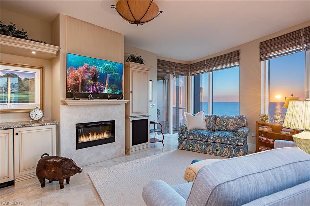 Experience spectacular Gulf and bay/city views from 10-foot window walls of glass in this higher-floor, three-bedroom, three-bath residence. This popular 03 floor plan, with creamy marble floors and sophisticated soft interiors by Janet Bilotti, is the ideal backdrop for the spacious interiors. Thoughtful modifications created an expanded family room, and the numerous additional custom features include built-in storage and cabinetry throughout the residence, and a built-in Murphy bed in the third bedroom/office. Also included are two screened and shuttered terraces and a rare private two-car garage. Aria is one of the finest buildings on Park Shore Beach, with an array of amenities including two luxurious guest suites, a state-of-the-art fitness center, men's and women's spa areas, a massage room, social room and private dining room, billiards room, and beachside pool, spa, covered bar and barbecue grills. Pet-friendly too.