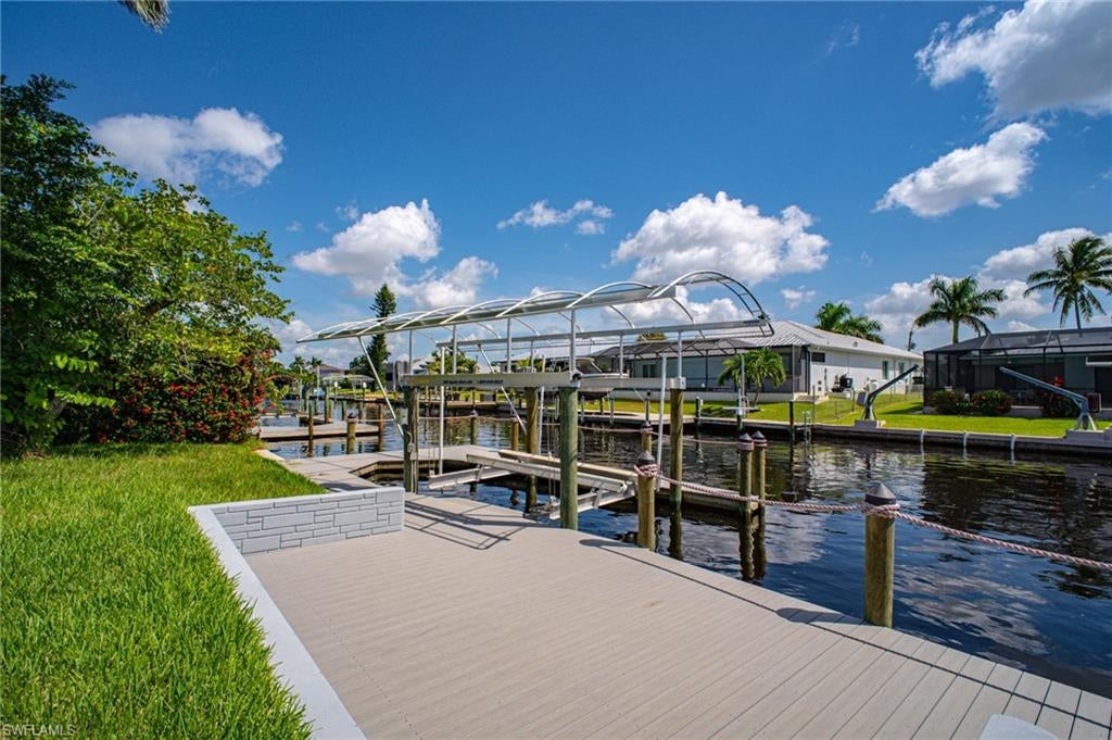 One or more photo(s) has been virtually staged, AI generated or rendered.  One or more photo(s) has been virtually staged, AI generated or rendered. Exclusive Waterfront Vacant Lot - 5259 Skylark Ct, Cape Coral FL. Cleared Lot-Approved Luxury Home Permit -Sea Wall-Open water access. Composite Dock built in 2025 (with captains walk) that spans the entire width of the back of the property, 15k lb Boat Lift w/ canopy, & Seawall. An exceptional oportunity to build a espectacular waterfront resident in Cape Coral. The previos older home has demolished, leaving a clean waterfront lot ready for new construcction. Even more valuable, property has an aproved Construction permit and Luxury Home Project designed in accordance with the 2023 elevation code requirements. 5 Bebrooms, 5 bathrooms, Great room, Designer kitchen, Private Home Theater, 3 car garage, Future Swimming Pool, Jacuzzi/spa and Expansive Pool Deck. Aproved Project Details: *Residential Occupancy R3, *Construcction Type V-B, *2023 Elevation Code, Existing Sewall, *Cleared Waterfront Lot, * Aproved Luxury Residential Projet Permit. The aproved permit is backet by a Highly experienced Miami Luxury Home Buider with more than 27 years os experience in HIGH-END and ULTRA-LUXURY Residential Construction. A prime Boating Location. The existing SEAWALL adds significant value and makes this property an aoutstanding oportunity for anyone looking to create a new luxury waterfront residence. THE LOT IS CLEARED, THE SEAWALL IS IN PLACE, THE PROYECT PERMIT IS APPROVED, THE WATER IS WAITING. Build new. Build Better, Built for the Future. Rendered and virtual photos in this advertisement.
