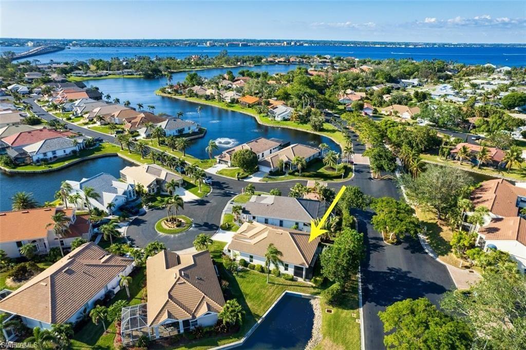 WELCOME HOME, BOATERS!
Discover coastal living at its finest in this stunning single-family home nestled within the highly sought-after Caloosa Yacht & Racquet Club. Perfectly situated in a premier boating community.  Inside, you’re greeted by soaring ceilings and an open, light-filled floor plan that flows seamlessly throughout. The gourmet kitchen is a showstopper, featuring 42-inch custom wood cabinetry, sleek quartz countertops, and stainless steel appliances—perfect for cooking, entertaining, or simply enjoying your morning coffee.

The primary suite serves as your private retreat, complete with a spa-inspired bathroom offering a soaking tub, dual vanities, and a spacious walk-in tile shower. Two additional bedrooms feature elegant wood plank tile flooring, while the main living areas showcase timeless tile throughout for easy, low-maintenance living.

Step out to your screened lanai and take in the serene water views, an ideal setting for quiet mornings, evening gatherings, or sunset cocktails. For boating enthusiasts, the Riverside Marina offers direct Gulf access, competitive docking fees, and available slips on a first-come, first-served basis—an exceptional amenity that’s hard to find in this location.

This home also features a newer lanai, roof, impact doors, HVAC system, and fresh paint inside and out, giving you total peace of mind and move-in-ready comfort.

Within the gates of this lush, private community, residents enjoy resort-style amenities, including a heated swimming pool, tennis courts, a scenic lakefront park, and exclusive access to the Blue Coyote Restaurant, a members-only culinary gem. Located just minutes from the McGregor corridor, you’ll be close to shopping, dining, and all the best that Fort Myers has to offer.

With its unbeatable combination of modern updates, elegant design, and coastal charm, this home isn’t just a place to live—it’s a lifestyle you’ll love coming home to. Home has NOT had any flooding or damage from past storms!