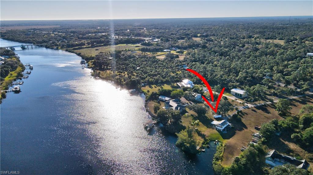 River front 1.52 acres with private yacht basin on the Caloosahatchee River East of Downtown Fort Myers. A great Safe harbour for your yacht! Dry land, the property has no known flooding. This 1.52 acre lot is located just north of Palm Beach Blvd or Hwy 80 east of Interstate 75. It is located on the Caloosahatchee River, in a friendly neighborhood. Your own private water front sancutary. Lots of new homes in the River Oaks Community.  The following mileages are approximate as the crow flies. 17 miles east of Downtown Fort Myers, 30 miles east of Fort Myers Beach and the Gulf of Mexico, convient to shopping and restaurants - Publix Shopping Center - 7 miles, Rooster's Route 80 - a popular farm stand for fresh produce, pies, ice cream & monthly vendor market is only 5.7 miles away, The Boathouse Tiki Bar & Grill - 10 miles by boat or car, 43 miles west of Lake Okeechobee, the largest lake in Florida and the second largest lake within the interior of the US covering 730 square miles. 98 miles west of Stuart Florida, the St. Lucie River connects Lake Okeechobee to the Atlantic Ocean and exits at Stuart. This lot is between the Franklin and Ortona Waterway Locks offering superior flood control. This property did not flood the recent hurricanes per the Owner and current Tenant. This property is 33 miles from RSW International Airport and 26 miles from the Punta Gorda Regional Airport.

PRIVATE YACHT BASIN: One-of-a-kind opportunity. This 1.52 Acre lot has 250’ of frontage on the Caloosahatchee River and features a Yacht Basin that was dug years ago .The basin is approximately 100’ x 40’. It would be nearly impossible to be allowed to dig a Yacht Basin like this today on a navigable water way leading to anywhere in the world. In a phone call to the county, we were told that it could be repaired/improved with the proper permits. This protective Yacht Basin is an extremely rare feature of this property offering excellent protection and ease of boarding with no vulnerable docks extending into the river. Please contact Lee County Permitting to confirm the possibilities.

STRUCTURE: A home exists on this lot that is currently housing a tenant. It is possibly a fixer upper. It is a concrete block structure.

VALUE: This is a one-of-a-kind property. It features a Yacht Basin that may be considered a “hurricane hole” by most insurance companies. This could lower the cost of insurance and reduce the need to move the vessel during impending storms. We recommend you check with your insurer as their rules may differ from company to company. This basin would allow a total wrap around style dock system with access to all sides of a large yacht plus dockage for multiple smaller vessels as it is around 40’ wide. Having a private yacht basin on your property may be nearly priceless.