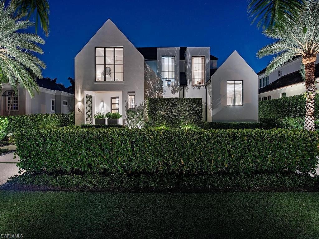 Custom built and designed by Harrell & Co., this architecturally distinctive residence stands apart in Old Naples, showcasing clean lines, dramatic ceiling details, and expansive floor-to-ceiling glass. Situated on one of the area’s most desirable streets, just blocks from 3rd Street South and the Gulf’s white sand beaches, the home features four en-suite bedrooms, two powder rooms, a private den, and a separate casita. The open-concept interior blends thoughtful architecture with refined finishes, including bespoke cabinetry and millwork, Wolf and Sub-Zero appliances, and European oak flooring. Walls of glass connect seamlessly to the outdoor living area, complete with a summer kitchen, pool, and spa. An oversized lounging area with artificial turf and southern exposure provides an ideal setting for enjoying the Florida sunshine. Additional highlights include a Lutron lighting system, motorized shades, private elevator, dry bar with both bar and wine fridges, whole-house 48 kW generator, natural gas, and electric roll-down screens and shutters. All three garages are air-conditioned and with alley access. A rare combination of architectural distinction, exceptional functionality, and refined coastal living in the heart of Old Naples.