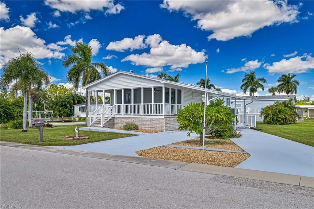 YOUR SLICE OF TROPICAL PARADISE AWAITS IN BAYSIDE ESTATES! Enjoy gorgeous canal views, visiting manatees, and the best of Southwest Florida waterfront living in this beautifully updated 2-bedroom, 2-bath, furnished home located in the highly desirable Bayside Estates boating community!

Built in 2006 and elevated higher than many surrounding homes, this spacious 1,188-square-foot residence features soaring ceilings, an open and inviting floor plan, luxury vinyl flooring, beautiful quartz countertops, a NEW A/C, and a durable metal roof! The oversized primary suite offers a walk-in closet and private bath with dual sinks. Additional conveniences include indoor laundry and plenty of room to relax and entertain.

Situated on a LARGE CORNER LOT with TWO DRIVEWAYS, this property offers exceptional outdoor space! Enjoy your morning coffee on the screened lanai, unwind on the patio, or simply take in the peaceful canal views and watch the manatees swim by. This is the Florida lifestyle you've been dreaming of!

Bayside Estates is a vibrant 55+ boating community offering an incredible selection of activities and amenities, all conveniently located near Fort Myers Beach, restaurants, shopping, and everything Southwest Florida has to offer!

Whether you're looking for a seasonal getaway or your full-time Florida retreat, this home checks all the boxes! Don't miss this opportunity to own your own piece of paradise. Schedule your private showing today!

Buyers pay a $2,800 resale capital contribution fee.