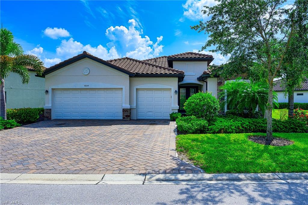 Welcome to this Pool home with peaceful lake view on an Oversized lot in Raffia Preserve! You will love the stunning outdoor living space along with the Comfortable interior layout of this Summerville II floor plan. Luxury features throughout- Relaxing Outdoor space with screened in pool & spa, volume & tray ceilings, designer grade cabinetry & countertops, Huge Primary Bathroom and closets = Two additional bedrooms and Full baths And a study / playroom/ flex room...  Plus - a THREE CAR GARAGE!!!  Raffia Preserve is a gated community w/ 184 acres of land w/ 72 acres designated to nature preserves and lakes. Fantastic location- 8 miles from the shoreline of Vanderbilt Beach, 15 minutes from the shopping & dining of MERCATO, and short drive to championship golf courses and public parks. This community is in one of the best school districts in SWFL and it has activities for every member of the family- resort style pool, 2k sq ft fitness area, clubroom, tot lot playground area, basketball court & open space that spans across 2.4 acres.