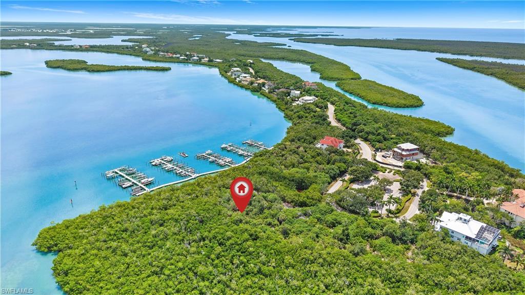 Unrivaled privacy meets grand-scale potential in this exceptional 1.34-acre homesite, situated within the exclusive, gated enclave of Key Marco. This generously sized parcel offers a rare canvas to curate your ultimate island lifestyle, complete with breathtaking, panoramic views of Barfield Bay. Skip the years of architectural guesswork. The sale of this magnificent property includes the complete plans for a meticulously crafted, one-of-a-kind, stunning, custom-designed elevated estate.  Whether lounging by a custom pool or hosting on expansive terraces, the home is engineered to frame this location's extraordinary gulf views.  Marco Island's preeminent builder, JP Homes, will build the home for Cost-Plus, or you can hire your own builder. All environmental and archaeological reports are done. Key Marco residents enjoy a newly renovated clubhouse with a fitness center, social room, and catering kitchen, alongside tennis and pickleball courts.  Even before building a home, you can enjoy direct Gulf access. Boat-owning lot owners may obtain a boat slip at no cost. The savings from renting a slip elsewhere could more than cover the association fees while your investment in the land grows.  Key Marco is the ultra-exclusive destination, and feels like a secluded, private island world of its own, yet you are mere minutes away from Marco Island's acclaimed dining, boutique shopping, vibrant entertainment, and world-famous crescent-shaped luxury beach.