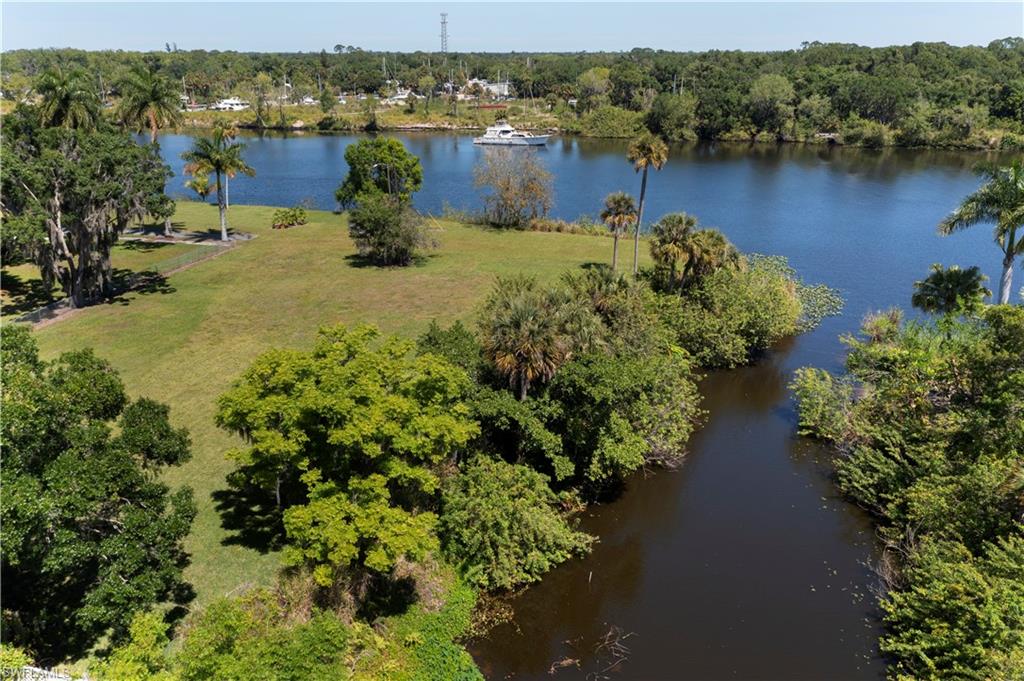 This beautiful, oversized parcel of land - almost 3/4 of an acre - has so much to offer including an ideal location within the City of LaBelle, just east of historic Barron Park. Seldom does one find a true corner homesite with stunning, unobstructed views of the beautiful Caloosahatchee River as well as additional frontage on a navigable canal. This lovely property has been cleared and is large enough to accommodate a substantial home in size, a pool, gazebo or other out-buildings. Of course, The Caloosahatchee Waterway is instrumental to boaters in providing access to the east coast of Florida as well as the Gulf to Mexico, so the boat traffic is both varied and entertaining to say the least. Additionally, the land is accessed through a private gate and is positioned in such a way ensuring there is no through traffic. This location is perfect in so many ways. Imagine having your own private oasis, with the river literally in your backyard, while being within walking distance to the Barron Park Art Gallery, library, and the wharf. All the celebrated activities at the park including Smoke under the Oaks, The Swamp Cabbage Festival and Parade and Christmas in the Park will be there for you to enjoy at your leisure, and of course, you'll have a private, front row seat to the 4th of July fireworks on the river. Call today for your private showing.