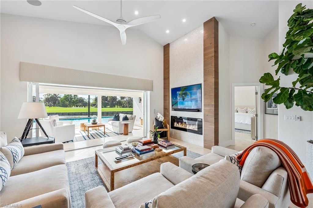 Full golf membership available! This thoughtfully re-imagined Eagle Creek estate home presents a refined approach to golf and country club living, positioned to capture sweeping water and fairway views across the club’s celebrated 18th hole. Offered with luxury furnishings, this beautifully remodeled residence features three bedrooms plus a den and 2.5 baths, with an open layout defined by soaring ceilings and abundant natural light. Expansive glass frames nightly sunsets over the course, best enjoyed from the generous lanai designed for year-round outdoor living. Interior appointments include marble flooring, premium lighting, an integrated Sonos audio system and a chef’s kitchen equipped with Wolf and Sub-Zero appliances. Recent improvements, such as a newer roof, impact-resistant windows and electronic storm screens, add modern efficiency and peace of mind. Outdoors, the lanai serves as a private retreat with a full summer kitchen, marble pool deck, oversized pool with water features and a panoramic screen enclosure that preserves uninterrupted views. Eagle Creek Golf and Country Club is an intimate, gated enclave set between Naples and Marco Island, offering an established lifestyle centered on championship golf, dining, tennis, fitness and social engagement. This residence offers a rare opportunity to enjoy privacy, scenery and club living in one of Naples understated communities.