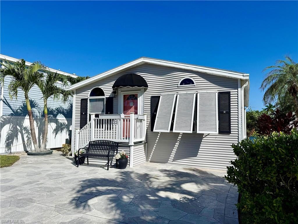 Beautiful home situated on the water! This 1Br/1Ba home is MOVE IN CONDITION and aesthetically ideal! You will appreciate the very recent updates (2026)— LG kitchen appliances, lanai furnishings (furniture, lighting, rug), polywood Adirondack chairs (rear patio), queen mattress (never used), and app-controlled thermostat. Other updates include flooring, kitchen countertops, cabinets, sink & faucet, hot water tank, and bathroom. The home is being sold furnished and includes some never opened home items. The home is extremely clean and well kept; plus, the relaxing water view can be enjoyed from the screened lanai, bedroom, and rear patio. The high ceilings and open floor plan are charming, and there is a sleeper sofa in the living room. On top of all of these fabulous features, YOU OWN YOUR OWN LAND when you purchase your NAPLES, FLORIDA home! It is situated within Imperial Wilderness Condominium Association, a gated 55+ community that was never flooded (and is not a co-op or land lease community)! IWCA is located approximately 3 miles to shopping and restaurants, 11 miles to the Naples beaches, and 8 miles to the Marco Island beaches. Airport access is also easily attainable— a 45-minute drive (RSW). Maximizing the opportunity to economically own property in Naples, FL, the HOA fee of $898. per quarter is exceptionally reasonable. That fee covers many of your needs: the advantage of a gated community, water, sewer, lawn care, basic cable, trash, recycling, and community amenities. Community amenities include 2 pools with spas, bocce, pickleball, pétanque, tennis, shuffleboard, billiards, ping pong, a library, clubhouse, 2 dog parks, and a nature trail. The community pet restriction is 1 pet (40 lb. max.). Electric golf carts are allowed, and there is an extremely active events calendar.
