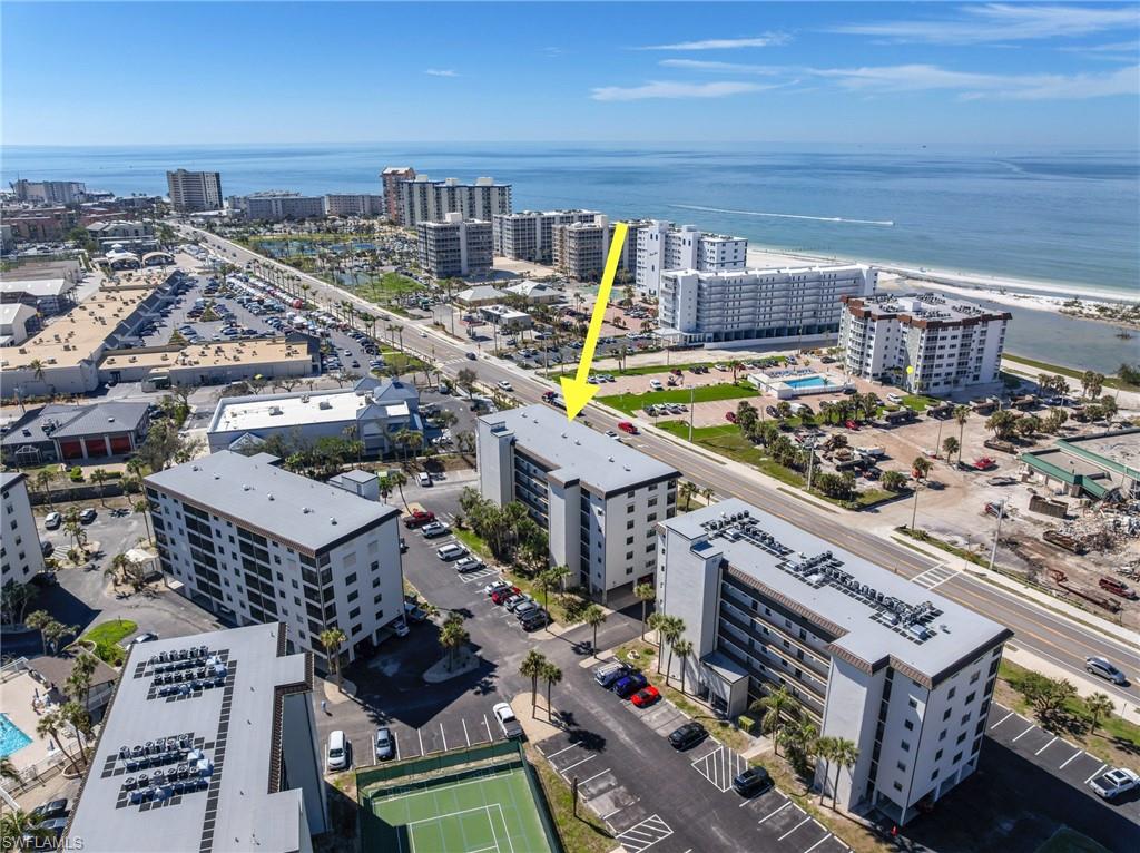 Welcome to your slice of paradise in Estero Cove! Highly desired CORNER UNIT with stunning 5th floor GULF views from your specious screened lanai!  Located in building 5 which is right across the street from the beach!  Features HURRICANE IMPACT SLIDERS and WINDOWS throughout, as well as HURRICANE SHUTTERS for added storm protection. This condo is well taken care of with so many updates! All windows and sliders have beautiful plantation shutters!  Newer electric panel, baseboards, doors, cabinets and counters! Luxury laminate flooring throughout and new tile on the lanai. Remodeled bathrooms both have walk in tiled showers with glass doors, granite counters, Kolar toilets, Moen faucets, and silent exhaust fans.  Additional updates include 2024 Water heater, 2022 AC unit and 2024 washer and dryer. Fantastic walkable LOCATION just across the street from the beach and next to Santini Plaza with shops and restaurants!