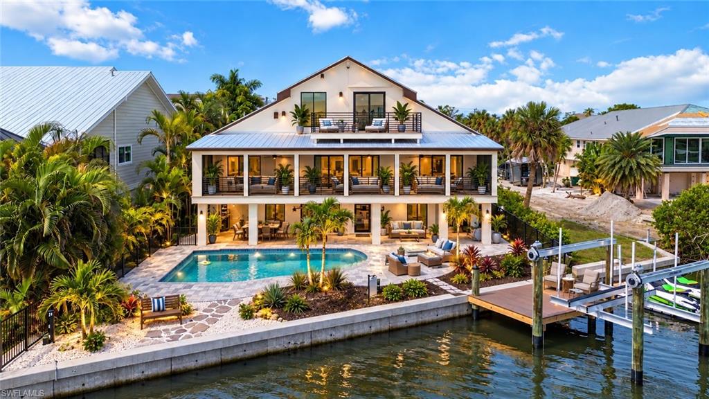 Experience the ultimate **Manasota Key waterfront lifestyle** in this extraordinary luxury coastal estate—where every detail has been reimagined and rebuilt to the highest standards. Situated on **1/3 acre along the tranquil waters of Lemon Bay**, this nearly new home offers the rare combination of **DEEDED BEACH ACCESS**, a **brand-new heated and chilled resort-style pool**, **new seawall**, **12'x10' dock with a 12,000-lb boat lift**, **kayak launch**, and **dual Jet Ski ports** for endless days on the water. Designed to impress, the home showcases panoramic views of Lemon Bay with breathtaking sunrises and sunsets from multiple balconies and patios. The open-concept living area centers around a spectacular chef's kitchen featuring **commercial-grade appliances, a 14-foot island, designer finishes**, and seamless indoor-outdoor living perfect for entertaining. The fully finished ground level dramatically expands the living space with a **35'x39' flex room** complete with drywall, epoxy floors, multiple sliding glass doors opening directly to the pool, and a full pool bath—creating the perfect game room, home theater, fitness center, guest lounge, or ultimate party space. A **10'x24' garage** provides additional storage, while the oversized front parking area easily accommodates boats, RVs, trailers, and offers room for a future workshop. Built for peace of mind, the home features **all-new impact windows and doors, new electrical and plumbing systems, new HVAC, luxury finishes throughout, and fresh tropical landscaping** that perfectly complements its coastal setting. Just a golf cart ride from island restaurants, waterfront dining, live music, and Gulf beaches, this is one of the few properties that truly offers it all—luxury construction, boating, beach access, expansive entertaining spaces, and unmatched waterfront amenities. **Bring the boat, the RV, the golf cart, the Jet Skis, and everyone you love—this is the beach house you've been dreaming about.** Parcel ID 411901329002