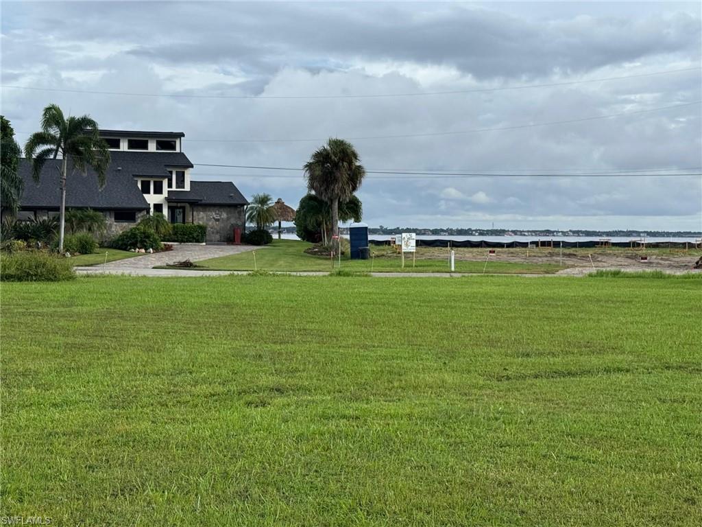 Spectacular newly created and landscaped .55 acre lot ready for your luxury home (potential plans attached) here on Seafan Circle in North Fort Myers. Private entrance and partial river views. Bring your builder or use ours! Utility pole at edge of property. Lower taxes as being county only taxes. A stones throw to Rosen Park for quick river access.