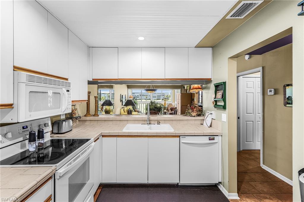 Attention investors, flippers, and equity-builders! This condo is priced aggressively for a quick sale and reflects its need for rehabilitation to execute your vision and maximize your return. The upside here is the price is firmly supported by recent market data, with several fully remodeled units in the neighborhood recently closing in the mid-$200ks. Bring your toolbelt, capitalize on the built-in margin, and unlock the undeniable potential of this diamond in the rough! Already completed are the wainscoted ceiling in kitchen - no DOME -, shiplap in the master bathroom, running bond pattern tile floor throughout - no carpet - , newer GE washer & dryer, and stainless steel gooseneck kitchen faucet. Augusta #209 is a beautifully positioned 2nd-floor condominium that perfectly blends convenience and the ultimate Florida resort lifestyle within the meticulously maintained Golfview Golf & Racquet Club community. This condo features hurricane sliders / windows transforming the lanai into a fully enclosed, air-conditioned, usable living space. This bonus square footage offers views of 3 fountain-equipped ponds, beautifully manicured landscape, and it overlooks the entire 9-hole Par-3 golf course. Golfview is an active NOT 55+ community with an on-site golf pro coordinating fun and challenging golf tournaments. There is also an active pickleball & tennis community. With a putting green & driving cage, fishing pier, and a walk/jog path there is always something to do! Located in close proximity to the SWFL beaches (Sanibel/Captiva & FMB), world-class shopping and dining. Entertainment venues (BBMANN Performing Arts Hall, Suncoast CU Arena) Sports Venues: Twins & Red Sox Spring Training Facilities; Parks and Recreation Venues: Lakes, Rutenberg, WaKeHatchee, and more - your adventures and activities are nearly endless. Medical facilities and houses of worship are also nearby. The GOLFVIEW LOCATION has so much to offer. Reasonable HOA fees include endless GOLF - NO additional green or tee fees, numerous amenities, water & sewer, cable/internet/wifi, golf course maintenance and more! Augusta and Golfview are in sound financial standing w/Milestone Inspection and SIRS reports available in Supplements. Other communities have similar HOA FEES but they don't offer a golf course! Call for a private showing today!