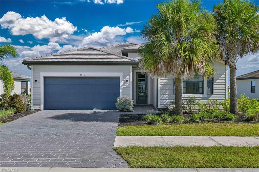 **LAKEFRONT HOME WITH CUSTOM INTERIOR DETAILS AND SUNSET VIEWS IN TIMBER CREEK!** Built in 2021, this 4-bedroom, 3-bath home offers 2,032 square feet of living space, a 2-car garage, and an oversized lakefront lot. The open living and dining area features a distinctive floor-to-ceiling, three-dimensional textured accent wall, while large sliding glass doors showcase expansive lake views and lead to the screened lanai. The kitchen offers white cabinetry, light countertops, a decorative tile backsplash, stainless steel appliances, a large island with seating, walk-in pantry, and eye-catching pendant lighting. The split-bedroom floor plan provides privacy, with a lakeview primary suite featuring dual sinks, a walk-in shower, and walk-in closet. Additional features include tile flooring in the main living areas, interior laundry, tile roof, and room for a future pool, subject to approval. NO FLOOD ZONE designation, makes this home even more affordable!  Timber Creek residents enjoy a 17,000-square-foot amenity center with resort and lap pools, fitness center, pickleball, tennis, indoor basketball, splash area, sauna, and on-site restaurant and bar. Conveniently located near I-75, RSW Airport, shopping, dining, and Gulf Coast Town Center.