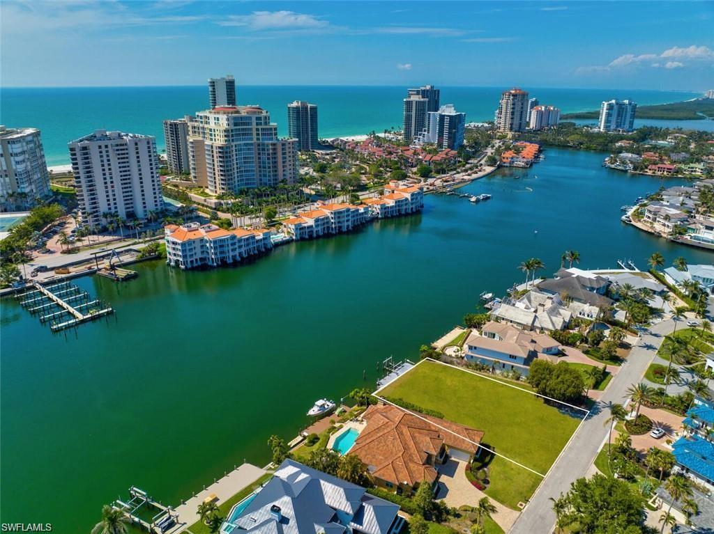Experience the quintessential Naples lifestyle with an exceptional opportunity to build your dream residence in prestigious Park Shore. This direct Gulf-access waterfront homesite offers desirable southwestern exposure, 105 feet of water frontage, and unobstructed sunset views. Envision a custom home with a rooftop mirador or viewing terrace to capture sweeping Gulf vistas and spectacular sunsets. Just a short walk away, the Park Shore Association’s private Gulf-front beach park offers members convenient parking, restrooms, and showers. The dining and boutiques of The Village Shops on Venetian Bay and Waterside Shops are also within walking distance.
