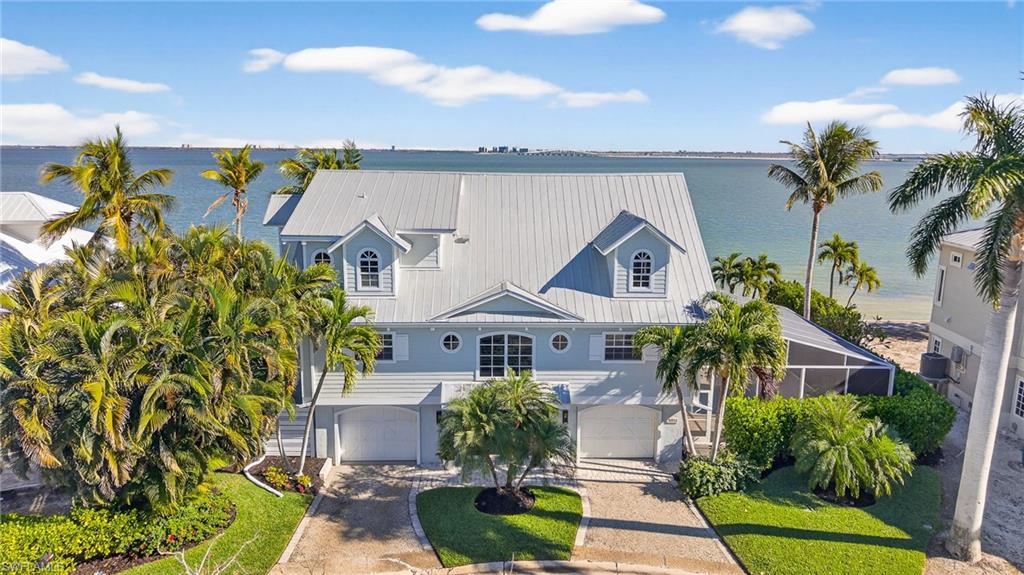 This exceptional fully furnished waterfront residence offers a refined coastal lifestyle with multiple indoor and outdoor living spaces designed to capture expansive bay views.
The main living level features an open-concept design with soaring vaulted ceilings and exposed beams, providing seamless flow from the kitchen to the living area and out to the waterfront balcony with endless views. Designed for both comfort, and entertaining. The kitchen is equipped with a gas range, and the living area is anchored by a fireplace, adding both functionality and warmth. Also located on the main floor are two bedrooms and two bathrooms, including a guest suite with an ensuite bath and bay views.
An elevator services all three levels, offering convenient access throughout the home. The private primary suite showcases incredible water views, a spacious bathroom, and an oversized walk-in closet.
Outdoor living is equally impressive, highlighted by a covered outdoor kitchen overlooking the pool and bay. A heated pool allows for year-round enjoyment, making this an ideal setting for entertaining and waterfront living.