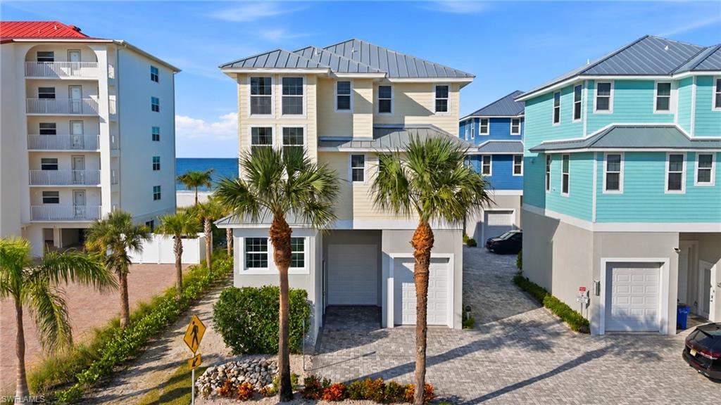 Experience elevated coastal living in this exceptional two-story beach home, ideally situated just steps from the sugar-white sands and Gulf waters of Fort Myers Beach. Located in a desirable weekly rental area, the property offers the flexibility to enjoy as a private beach retreat while also providing excellent rental potential. Beautifully appointed and filled with natural light, the residence combines refined finishes, generous living spaces, and gorgeous Gulf views with an effortless indoor-outdoor lifestyle. The open-concept main living area features a well-equipped kitchen with stainless steel appliances that flows seamlessly into the dining and living spaces. Multiple Gulf-view balconies extend the living area outdoors, providing inviting spaces for morning coffee, alfresco dining, and spectacular sunset views.

The spacious primary suite is a private retreat featuring a king-sized bedroom, wet bar, luxurious Jacuzzi tub, and an expansive private balcony overlooking the Gulf. An additional generously sized guest bedroom with its own en-suite bath provides comfort and privacy for family and guests.

Additional features include a full laundry room, ample storage, and quality finishes throughout. Residents also enjoy a heated community pool shared exclusively by the four homes within the intimate Key West Court enclave. The location offers exceptional convenience, with Publix, a nearby marina, restaurants, shopping, and the Fort Myers Beach trolley all within walking distance.

Whether enjoyed as a full-time residence, seasonal retreat, or income-producing investment, this distinctive beach home delivers an exceptional combination of Gulf views, rental flexibility, privacy, convenience, and the relaxed coastal lifestyle that makes Fort Myers Beach so desirable.