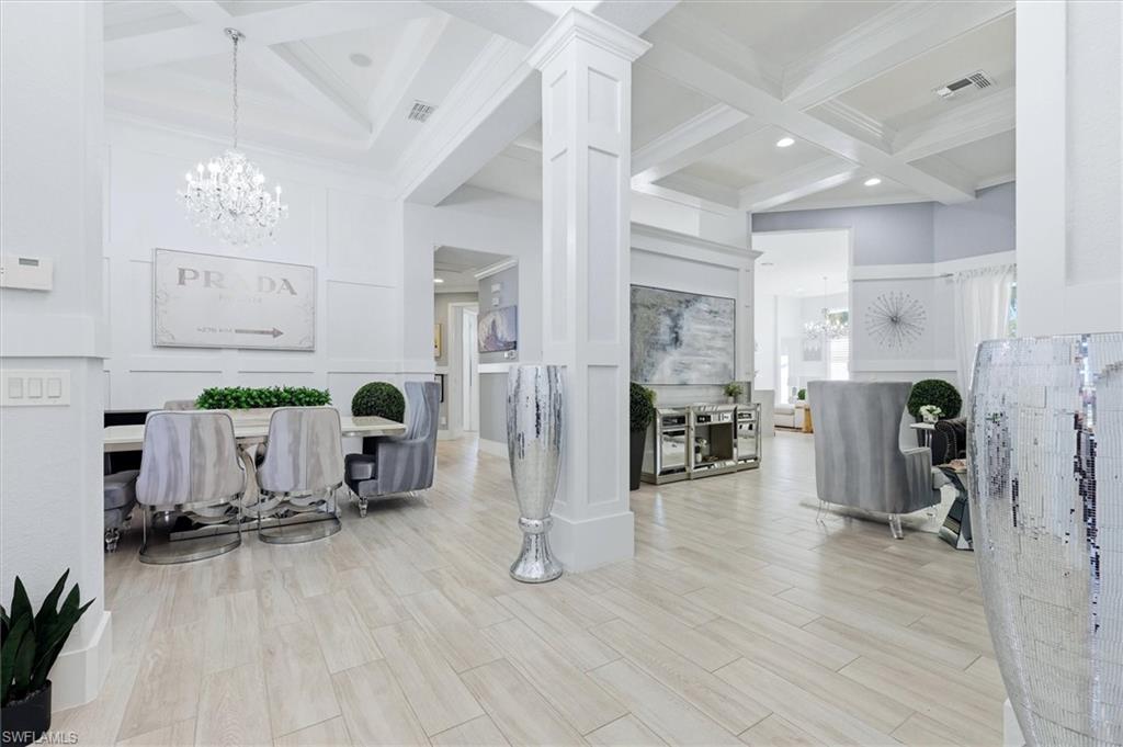 This is the one! A rare South Fort Myers gem, this highly coveted Malibu floor plan offers a true 3-CAR GARAGE, nearly 3,000 sq. ft. under air, 4 beds+den and 3.5 baths on a single level, transformed with over $200k in upgrades into a home that shows like a model. Privately positioned on an oversized, pie-shaped homesite along an intimate eyebrow loop, it enjoys exceptional separation from neighboring homes and sought-after southern exposure that bathes the home in natural sunlight throughout the day. From the moment you enter through the double doors, the difference is unmistakable: soaring ceilings, extensive custom millwork and trim, 10" baseboards, crown molding, coffered ceilings, plank tile flooring, plantation shutters, tray ceilings, and designer lighting create a polished, sophisticated interior rarely found at this price point. Your new kitchen features raised-panel cabinetry, an oversized island, waterfall-edge quartz countertops, full-height quartz backsplash, and Samsung appliances, opening to generous living and entertaining spaces. Double doors lead to your primary retreat, with a huge picture window, coffered ceiling with designer chandelier, and his and hers walk-in closets that use all 13' of ceiling height. The expansive primary bath has his and hers vanities, makeup vanity, separate water closet, linen closet and spacious walk-in shower with body jets. Another set of double doors opens to a sunlit 16'8" x 10'6" flex space, ideal for an office, nursery, gym or home theater, with a half bath steps away. Two separate guest wings provide privacy for all. The front wing features two oversized bedrooms with a Jack and Jill bath, while a secluded guest suite with walk-in shower and spacious closet is tucked away at the back of the home with its own back entrance. Impact-glass sliders open to over 1,000 SF of outdoor living, including a 300+ SF covered lanai. Solid side walls combine privacy and airflow, and the cage soars tall enough for shooting hoops on a 10' basketball goal. Upgrades continue with two newer A/C systems, 80-gallon water heater, central vacuum, built-in closet system, epoxy-finished garage floor, brick-paver driveway and tile roof. Even the furnishings are negotiable, so you can start enjoying the Florida lifestyle immediately! Gated Laguna Lakes is known for its active lifestyle, with community events, food trucks, pickleball, volleyball, sidewalks throughout, an infinity-edge resort-style pool, children's pool, clubhouse with card room, social kitchen and fitness center, playground, gazebo and fishing pier. The Bass Road entrance puts HealthPark Medical Center, Canterbury School, shopping, dining and the beaches of Ft Myers and Sanibel minutes away. If you've been searching for a single-level, three-car garage home with more than three baths in South Ft Myers, you know they don't exist. You won't come close to another home like this for less than $1.2M. This one won't last, so schedule your private showing today!