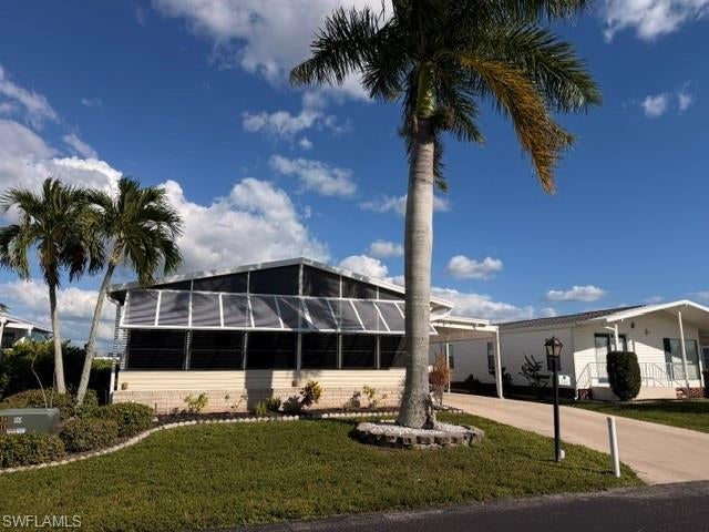 Welcome to your Florida paradise! Discover this immaculate, beautifully maintained manufactured home, offering over 1500 square feet of comfortable living space in a desirable gated  55+ community where You own the Land!

This spacious home features two bedrooms plus a den, a stunning upgraded primary bathroom with tile finishes and double sinks, a brand-new central air conditioning system installed in October 2026, and a new shingle roof installed in 2023. An added benefit is the reverse osmosis home water purification system.  Relax in your large enclosed lanai, enjoy the convenience of a carport, and appreciate the generously sized yard offering plenty of outdoor space. 

Just a short stroll to the pool, hot tub, and two-story clubhouse. This active community offers numerous amenities, including pickleball, billiards, a large dance floor, tennis, bocce ball, shuffleboard,  and a scenic pool overlooking a picturesque pond and fountain.
Conveniently located a short distance from Fort Myers beaches and Sanibel Island, as well as the area hospital, restaurants, and shopping. Enjoy the Florida lifestyle with Low HOA fees and the added benefit of owning your own land. 
Move-in-ready and waiting for you!