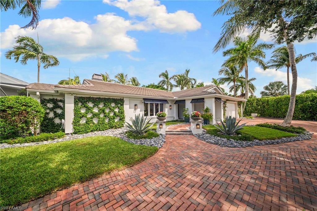 Fully renovated from top to bottom in 2018 and offering 136' of private water frontage, this beautifully maintained Naples waterfront home delivers the finish level, comfort, and peace of mind buyers often seek in newer construction. While preserving the charm of an established Naples property, nearly every major component was thoughtfully updated, including the roof, impact windows and doors, kitchen and baths, drywall, electrical, plumbing, paint, and finishes throughout. This was a comprehensive renovation designed to make the home feel like new construction.

Designed for easy one-level living, the home is simple to maintain while still living large in the main spaces. The open main living area features a high-end kitchen with walk-in pantry and spacious great room all overlooking the lush private backyard. Two guest bedrooms are thoughtfully split from the primary suite, along with two full bathrooms. The primary suite offers a unique indoor-outdoor experience with direct access to a private screened spa area featuring a hot tub with multiple jets and covered lounge space.

Outdoors, the property is truly exceptional and private. A new pool in 2018 showcases stunning authentic Greek marble slab work carried throughout the pool and floor, creating a clean, timeless, and incredibly low-maintenance finish. The north-facing screened lanai provides a shaded place to relax and watch TV, while the expansive sun-filled backyard offers an outdoor grilling area, dining under a large pergola, authentic permitted chickee hut, lush privacy landscaping, and rare open yard space.

For serious boaters, the property offers direct Gulf access with no bridges, double boat slips currently accommodating a 20' and 36' boat, and beautiful sunset views down the long canal to the west from the chickee hut. The two-car garage is air-conditioned and offers excellent storage. The home also remained dry during Hurricane Ian, making this level of renovation, condition, and waterfront security especially hard to find.

All of this is in an unbeatable Royal Harbor location, just minutes by boat to the Gulf and a short drive or bike ride to downtown Naples, 5th Avenue South, dining, shopping, and beaches. A rare and truly special waterfront property that has been loved, improved, and maintained at an exceptional level. Come see what exceptional waterfront living can be like at 2030 Snook.
