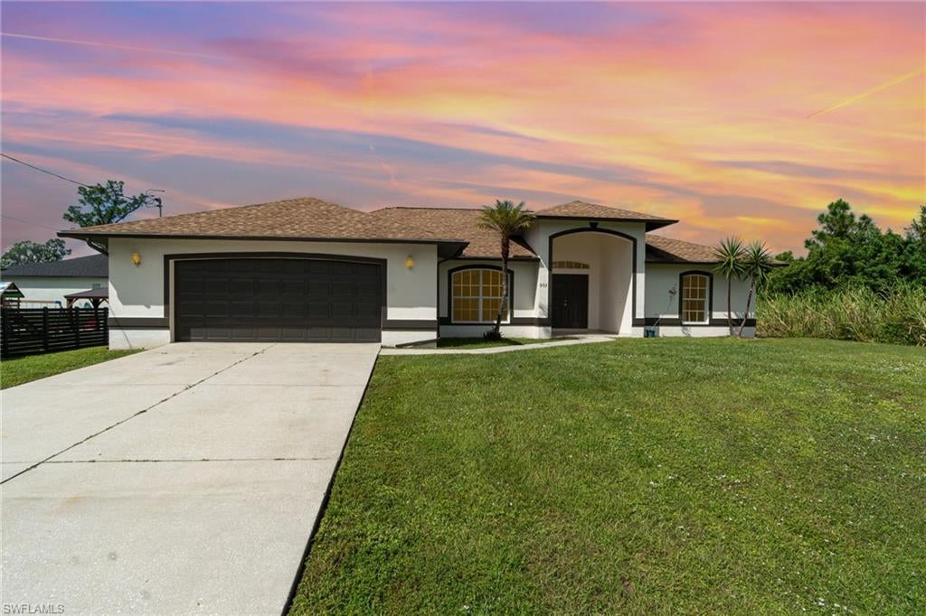 Discover your dream home on this beautiful 1/2 acre lot, offering the perfect combination of space and comfort. This charming three-bedroom, plus a den and a two-bathroom residence features an open floor plan that seamlessly connects living areas, making it ideal for entertaining or family gatherings. Enjoy the convenience of split bedrooms for privacy, while a dedicated laundry room  and walking closets in every room adds practicality to daily life.  The heart of the home boasts a spacious kitchen with a pantry, complemented by cathedral ceilings that enhance the airy feel throughout. Sliding doors invite natural light and open up to a backyard oasis, where you’ll have plenty of room for a pool! Retreat to the master suite, complete with a walk-in closet and a luxurious master bath featuring dual sinks, a separate tub, and a refreshing shower.  Additional highlights include tile throughout, a screened lanai  and an attached two-car garage. Don’t miss out on this incredible opportunity to create lasting memories in your ideal home!