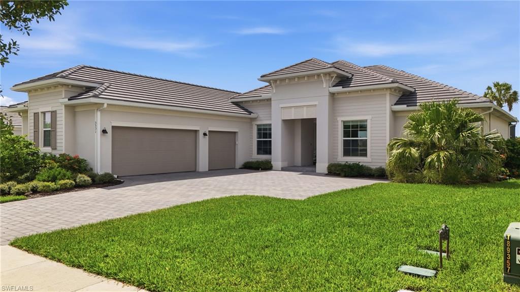 Beautiful Napoli estate home set in The National Golf and Country Club at Ave Maria.  This home hands you the view first. Golf and water stretch out beyond the lanai, framed by a stunning poinciana tree that turns every morning coffee or evening glass of wine into something worth pausing for. The lanai itself has been upgraded with storm-smart hurricane shutters and a full no-see-um side screens, so that view is something you can actually enjoy in comfort any time you want. New privacy plants added this past summer only deepen that feeling of having your own quiet retreat.

Inside, the open layout gives you room to gather without ever feeling closed in, while an air-conditioned three-car garage and a few thoughtful touches like updated lighting and fans and Frigidaire Gallery appliances mean the home works as hard as it looks good.

This home comes with a social membership that includes all the clubhouse dining, the resort-style pool, tennis, pickleball, bocce, and a full calendar of social events, along with time on the course when the season allows. And beyond that is Ave Maria itself, a true small town where people still know their neighbors and life moves at a pace that actually feels like living.  Quick close possible.  

This is not just a home. It is permission to stop waiting and start enjoying. Schedule your private tour today.