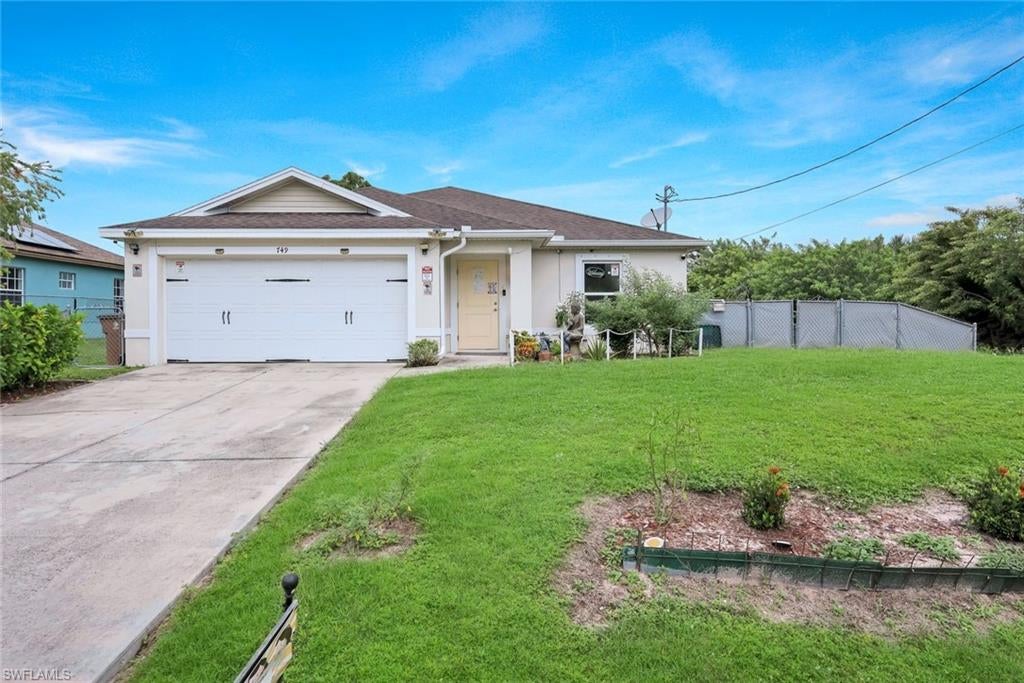 Welcome to this beautifully maintained and lovingly cared-for 3-bedroom, 2-bath home in Lehigh Acres, offering 1,629 square feet of comfortable living space in a rapidly growing area. This inviting single-story residence reflects pride of ownership throughout, offering a wonderful combination of comfort, functionality, and charm. The home features an attached two-car garage, a wide driveway, and a welcoming front lawn.

Inside, you’ll appreciate the care and attention this home has received over the years. The kitchen opens to the main living area, creating an easy flow for everyday living and entertaining. Wood cabinetry, generous counter space, and a breakfast bar make the kitchen both practical and welcoming. Tile flooring adds durability in the kitchen and select areas, while a carpeted living space offers a cozy place to unwind. Sliding glass doors connect the interior to the backyard, bringing in natural light and enhancing the home’s inviting atmosphere.

Outdoors, enjoy a spacious fenced yard with room to garden, play, entertain, or simply relax. A covered outdoor area provides another wonderful space to gather and enjoy the Florida weather. Meticulously cared for and thoughtfully maintained, this home offers buyers the opportunity to enjoy a property that has clearly been treated with pride and attention. With Lehigh Acres continuing to grow, this is a fantastic opportunity to own a well-kept home in an expanding Southwest Florida community. Come experience the warmth, comfort, and pride of ownership this property has to offer!