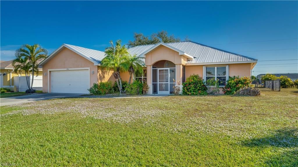 Well-maintained 3 Bedroom, 2 Bathroom home offering approximately 1,718 sq ft of living area with a spacious living room and family room layout, soaring vaulted ceilings, and a desirable split-bedroom design. The interior features a centralized kitchen with a walk-in pantry, and an inside laundry room. The large primary suite includes double sinks, a garden soaking tub, separate shower, and walk-in closet. The screened rear porch provides enjoyable outdoor space with convenient guest-bathroom access, and the backyard offers plenty of room to add a pool. Recent updates include a 2021 AC, 2019 metal roof, 2011 Hot Water Heater, 2010 4' chain-link fence with 5' mower gate. Also accordion hurricane shutters protect slider doors and windows. Flooring replacement may be required; condition has been factored into the list price. NOT IN A FLOOD ZONE! ALL ASSESSMENTS PAID. Prime SE Cape Coral location near Santa Barbara Blvd. and Veterans Parkway with convenient access to beaches, shopping, restaurants, and schools.