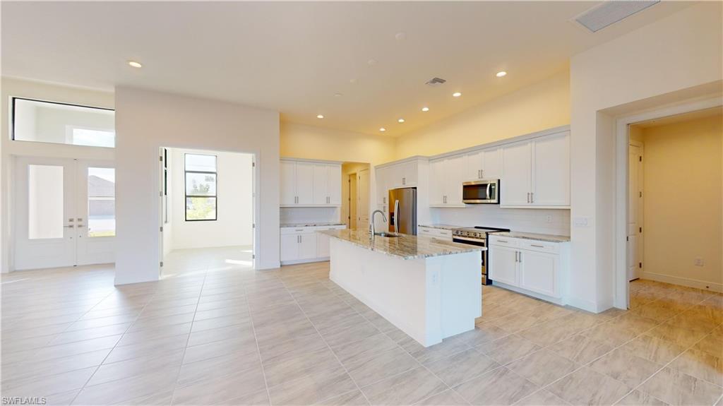 Brand New, Move-In Ready Built by Frey & Son Homes with Gulf Access  – Offering nearly 2400 sq. ft. of luxurious living space, this stunning home is designed to embrace the best of Southwest Florida living. Boasting an open great room concept, this spacious layout is perfect for entertaining guests or relaxing in style while enjoying picturesque waterfront views.

The home features 3 generously sized bedrooms and 2 beautifully appointed full baths, providing both comfort and privacy. The expansive 3-car garage offers ample space for your vehicles, toys, or extra storage. Step outside to your very own outdoor paradise with a custom-designed pool, spa, and sun shelf, all set within an oversized lanai that’s perfect for al fresco dining, lounging, and soaking up the Florida sunshine.

Premium features include soaring 11' ceilings in the great room, 10' tall pocket sliders that seamlessly open to the lanai, and full hurricane impact glass throughout for ultimate peace of mind. The chef-inspired kitchen is a dream, with 42" upper cabinets, Level 3 granite countertops, and a sleek, modern design that will inspire your culinary creativity. Upgraded tile flooring flows throughout the main living areas, adding a touch of elegance to every room.

This home also includes a security system for your safety, and is pre-plumbed and pre-wired for a future outdoor kitchen, offering limitless possibilities for future customization. The paver driveway and paver pool deck add sophistication and curb appeal, making this home as beautiful on the outside as it is on the inside.

With its gulf access, luxurious finishes, and spacious layout, this home provides the perfect combination of style, comfort, and functionality, ideal for those seeking the ultimate Florida lifestyle. Don’t miss the chance to make this dream home your reality!