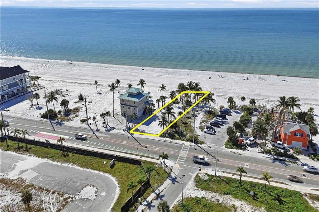 One or more photo(s) has been virtually staged, AI generated or rendered.  A Rare Opportunity to Craft a Gulf-Front Masterpiece. Perfectly located in the HIGHLY DESIRABLE 3000 Block of Fort Myers Beach. Imagine UNLIMITED SUNSETS every day from your Coastal Retreat. Discover an extraordinary offering along one of the most coveted stretches of shoreline on the island—an Amazing Gulf-front homesite where the possibilities for creating a world-class coastal retreat are as limitless as the horizon itself. This exceptional parcel stands as a rare invitation to design and build a bespoke luxury residence, tailored to the exact standards and lifestyle of its future owner. Poised gracefully on an immaculate span of sugar-white sand, the property is framed by a natural tapestry of low-lying coastal vegetation, enhancing both the beauty and privacy of the setting. This subtle, organic buffer evokes the timeless charm of “Old Florida”, creating an intimate sense of seclusion while still allowing the rhythmic sound of Gulf waves to become the soundtrack of daily life. Here, your outdoor living, pool, and entertainment areas can fully embrace the serene, uninterrupted ambiance that only true Gulf-front living can provide. The location is nothing short of ideal—perfectly balanced between tranquility and convenience. Enjoy quick access to the refined dining, boutique shopping, and vibrant energy of the North End, while returning home to the peaceful stretch of beach renowned for its quiet elegance and understated exclusivity. It is a setting that feels worlds away, yet remains close to everything that makes the island such an extraordinary destination. Whether you envision a private luxury compound, a seasonal coastal haven, or an investment property designed for premium return, this homesite offers the scale, flexibility, and design freedom to realize a truly exceptional estate. With sweeping Gulf vistas, dramatic sunsets, and a setting that elevates every architectural possibility, the canvas is ready for your vision. Opportunities of this caliber are exceptionally rare. Become part of the island’s remarkable renaissance and let your dream of GULF-FRONT living in PARADISE take shape on this premier homesite. Introductions to highly regarded, well-qualified luxury builders are available upon request.