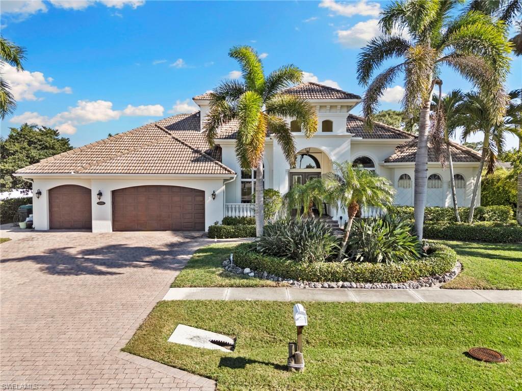 HAVE MULTIPLE OFFERS.  ACCEPTING OFFERS UNTIL 2/6 AT 11AM.  Welcome home to your Marco Island private oasis!  Boasting 3027 SF of a generously open floor plan, this home is entered through double front doors into the elegant living room featuring impressively high tray ceilings which spotlight the gas fireplace flanked by floor-to-ceiling recessed display cases.  Approximately fifty linear feet of glass slider walls in the living and family rooms open onto the 619 sq ft screened lanai and pool with remotely controlled hurricane rated storm screens. The kitchen features custom cabinets with huge storage capacity, granite counters, and a new refrigerator and dishwasher. Adjacent is the walkthrough wet bar with a new beverage cooler where you can prepare your morning coffee or evening wine to enjoy sunset.  The spacious primary bedroom has two walk-in closets and french doors opening onto the swimming pool, while the primary bath has separate his & hers vanities and spectacularly remodeled walk-through dual showers.  The guest bathroom features a lanai exit for easy access from the pool.  A 2020 upgrade included new plank tile throughout, enhanced lighting, additional bathroom updates, and replacement of all dual-zoned HVAC components.  A 3 car garage includes ample storage.  Mature landscaping includes 7 varieties of palm trees with a lushly screened, fenced backyard providing a substantial dog run.  The home's ZERO flood history due to its' quality build and elevation along with all opening protection systems provide peace of mind. This timeless home is perfect for entertaining, relaxing and enjoying the island lifestyle.