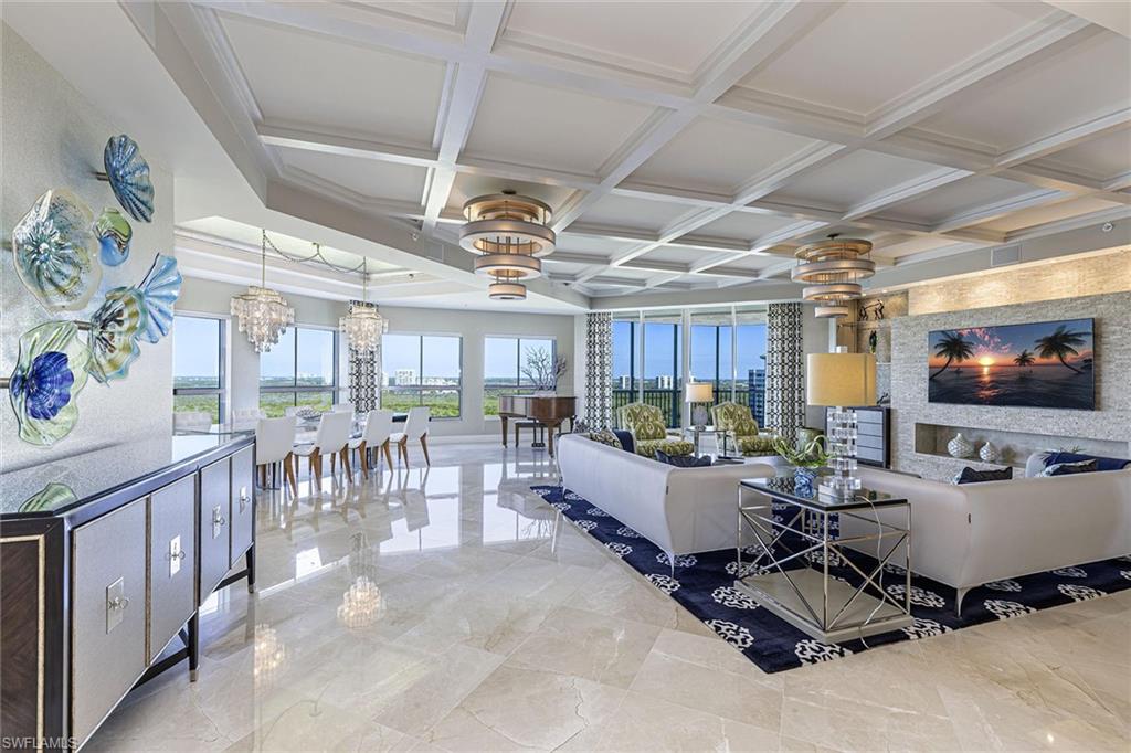 One or more photo(s) has been virtually staged, AI generated or rendered.  Positioned on the 18th floor, this one-of-a-kind, double penthouse features exceptional floor-to-ceiling windows throughout with panoramic Gulf views. This spacious, rarely available residence offers two generous living areas, that flow into the light-filled outdoor living space, creating the ambiance of a private single-family home. A thoughtfully designed floor plan, enhanced by refined upgrades throughout, includes a walk-in pantry, travertine flooring, custom finishes, intricate crown molding, striking millwork, double ovens, and a beautifully appointed lanai bar complete with built-in barbecue and wine refrigerator, ideal for entertaining against a backdrop of sunset skies. The primary suite offers stunning views, a dedicated exercise room and a spa-inspired bath. Three guest suites each include private terraces and en-suite baths. In addition, the residence offers an oversized two-car climate-controlled garage with EV chargers and a newly renovated poolside cabana. The Dunes is a resort-style community offering professionally staffed tennis courts, a full-service restaurant and bar, a state-of-the-art fitness center and a spectacular zero-entry resort pool with spa. Concierge services are available six days a week, complemented by an on-site property manager who resides on the premises. This residence also includes a transferable membership to the exclusive Floridian Beach Club, a luxurious beachfront escape.