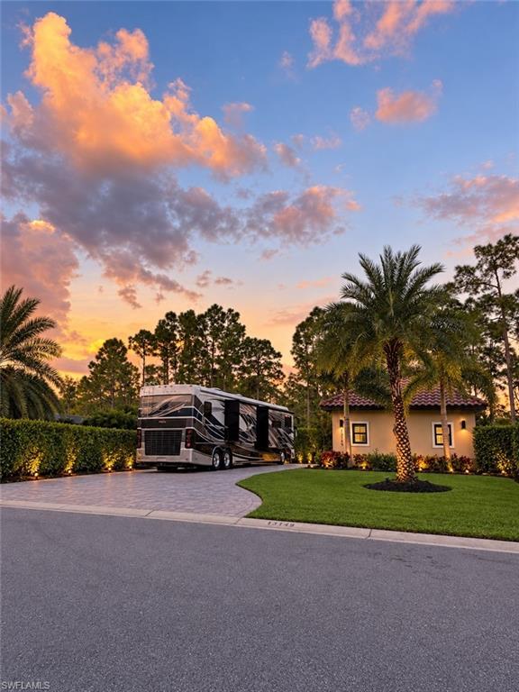 SPECTACULAR WATERFRONT RETREAT | GOLDEN PALMS LUXURY MOTORCOACH RESORT | LOT 94

Your waterfront oasis awaits! Experience luxury Class A and Super C motorcoach living, where breathtaking water views, tropical surroundings, and exceptional attention to detail create a distinctive Florida retreat.
RV enthusiasts discovering Golden Palms quickly realize what makes this boutique resort special. Oversized lots, expansive paver driveways, and custom coach cabanas create a community of remarkable individuality. Each cabana reflects its owner's vision through distinctive architectural details, custom upgrades, and upscale appointments, making every property a unique experience.
Lot 94 beautifully captures that individuality! Ideally positioned along the resort's picturesque 22-acre lake, this east-facing waterfront property offers those long water views, gorgeous sunrises, and welcome afternoon shade. 
Attention to detail is evident upon arrival. Coordinated gray pavers, lush tropical landscaping, and beautifully designed driveway, walkway, and landscape lighting create outstanding curb appeal. At night, the property transforms into an illuminated tropical oasis. The expansive motorcoach pad accommodates your Class A or Super C, with room for a stacker trailer striped to complement your coach, subject to resort guidelines.
Outdoor living is exceptional! The 335-square-foot screened lanai captures magnificent waterfront views while lush landscaping provides a wonderful sense of privacy. An extended paver patio offers another inviting gathering space, perfect for enjoying cooler Florida evenings with friends around the outdoor fireplace.
The beautifully appointed custom coach cabana (“casita”) offers 840 square feet under roof, featuring an elegant living area, gourmet kitchen, dedicated wine and coffee bar, full bathroom, and laundry. Upscale finishes and thoughtful appointments enhance every space. A versatile flex room provides additional possibilities, including room to park your golf cart if desired. Furnishings are optional and negotiable.
Life at Golden Palms extends beyond your private retreat! This gated luxury motorcoach community features a beautiful clubhouse, heated pool and spa, sauna, fitness center, pickleball and bocce courts, one-acre dog park, and a 22-acre lake with catch-and-release fishing. An active calendar of social gatherings and activities creates a welcoming atmosphere where friendships flourish.
Ideally located in Fort Myers, Golden Palms offers convenient access to outstanding dining, shopping, golf, Southwest Florida International Airport, spring training baseball, boating, fishing, and the celebrated Gulf beaches of Sanibel, Captiva, and Fort Myers Beach. Whether exploring Southwest Florida's coastal treasures or relaxing in your waterfront retreat, the best of the Florida lifestyle is within reach.
Spectacular by day. Magical by night. Your waterfront oasis at Golden Palms awaits!