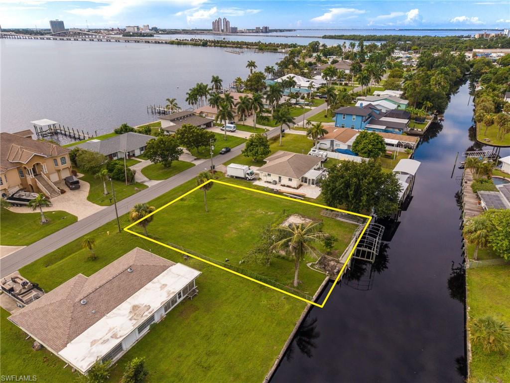 Build your waterfront home on this 0.28-acre canal-front lot in North Fort Myers with quick boating access to the Caloosahatchee River and beyond to the Gulf! The previous home was removed in 2023, leaving several valuable improvements already in place, including an in-ground pool, private dock, 10,000 lb boat lift, and approximately 94 feet of seawall. The wide canal provides sailboat access with no bridges and is just a short idle to the river, making this an ideal property for boaters looking to enjoy the Southwest Florida waterfront lifestyle. With much of the outdoor infrastructure already established, you can focus on designing a new home around the pool and waterfront setting. Conveniently located near Downtown Fort Myers, restaurants, shopping, and local attractions, this property offers a unique opportunity to create a custom waterfront residence in a central location.