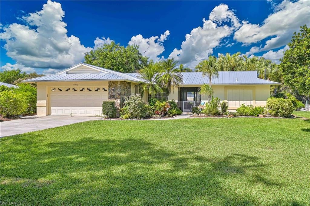 Exquisite "Boater's Dream"  "Double Lot" POOL Home, 3 bedrooms, 2.5 baths in a quiet well maintained neighborhood the whole family will enjoy. The property features a double lot with mature palm & oak trees, plus beautifully matured landscaped on almost one acre. Boat dock, 10,000 lb. boat lift with a small slip launching for kayak/jet skis. 25x30 Workshop, 10x18 shed and back yard is accessible from separate driveway, also great for RV/Boat parking. NO HOA FEES. Interior of the home boasts of upgrades including beautiful tile flooring throughout, new cabinets, quartz countertops, and stainless steel appliances. Large covered lanai and screened pool deck provides the ultimate in private indoor/outdoor living. Pool includes electric heater. Seasonal getaway in PARADISE or the perfect family home with lots of room!. HOUSE ROOF New 2019, Shop Roof 2023, AC 2020, Water Heater 2015, Water Equipment 2018, Reverse Osmosis System under kitchen sink & New Electrical Sub Panel 200 AMP Service 8/2026. Elevation Certificate & Survey available upon request. Inquire today before this one slips away.