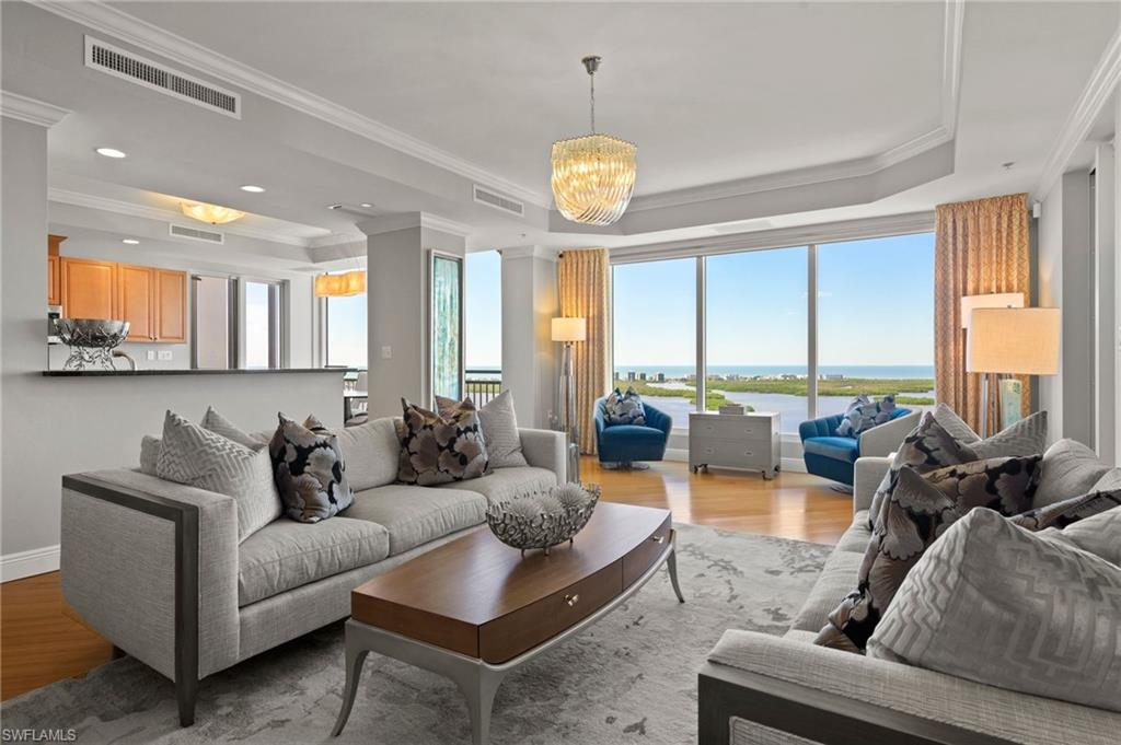 Welcome Home to spectacular high-rise living in Esperia at Bonita Bay! This beautifully appointed 2-bedroom plus den, 2.5-bath residence offers breathtaking views of Estero Bay, the Gulf, and the lush golf course beyond. Floor-to-ceiling windows showcase the magnificent scenery, while wood flooring and electric shades complement the spacious living and dining areas. Enjoy entertaining family and friends in the well-appointed kitchen featuring granite countertops, stainless steel appliances, a gas cooktop, and abundant cabinetry. Step outside to the screened lanai, complete with a gas grill, and take in the spectacular Gulf sunsets! The primary suite is a private retreat with direct access to an open-air balcony, a custom walk-in closet, and an en-suite bath featuring dual vanities, a walk-in shower, and a soaking tub. Guests will appreciate their own private suite with lanai access and an en-suite bath. The versatile den offers additional space for an office or guest accommodations. Esperia amenities include a resort-style pool and spa, fitness center, club room, billiards and card rooms, and guest suites. Enjoy the extraordinary Bonita Bay lifestyle with a private Gulf beach park, full-service marina, waterfront parks, and miles of scenic walking and biking paths. Optional Bonita Bay Club membership offers championship golf, tennis, pickleball, exceptional dining, and more. Come enjoy the magic of Bonita Bay living!