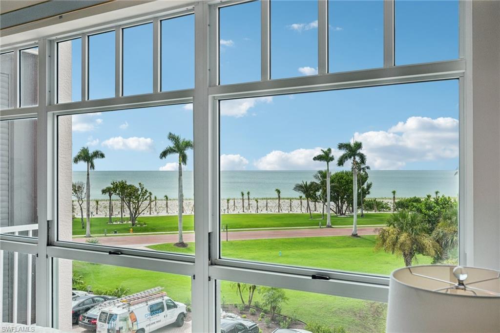 Offering a rare blend of Gulf-front drama and peaceful bayfront beauty, this 3-bedroom, 2-bath residence at Barefoot Beach Club showcases a truly exceptional dual-waterfront setting. With sweeping, ever-changing views of the Gulf of Mexico complemented by serene Bay vistas, the home captures a perspective few properties can rival—all just steps from the sand, where beachside living becomes part of your everyday routine. Designed with both comfort and functionality in mind, the light-filled interior features a well-planned split-bedroom layout that provides privacy without sacrificing an open, airy feel. The main living spaces are thoughtfully positioned to maximize water views, naturally drawing the eye outward. A screened lanai extends the living area, inviting in coastal breezes and the soothing sound of the surf, while serving as the perfect vantage point for unforgettable Gulf sunsets. The kitchen is bright and practical, appointed with white cabinetry, ample storage, and a convenient breakfast bar ideal for casual dining or entertaining. Privately situated along the water, the primary suite offers a tranquil retreat with stunning Gulf views, direct access to the lanai, a spacious walk-in closet, and an ensuite bath featuring dual vanities, a glass-enclosed shower, and a separate soaking tub. Two additional guest bedrooms are located at the front of the residence, providing comfort and separation for family and visitors alike. Whether enjoyed as an immediate coastal getaway or reimagined to reflect your personal style, the home is move-in ready and equipped with impact glass and hurricane shutters for added peace of mind. Residents of Barefoot Beach Club benefit from a gated, amenity-rich environment, including access to miles of pristine beachfront, resort-style pools and spas, a newly renovated clubhouse with fitness center, and professional on-site management. Optional membership to the Club at Barefoot further enhances the lifestyle with tennis, dining, and full beach services. Conveniently located just minutes from Mercato, Waterside Shops, and Southwest Florida International Airport, this residence presents a rare opportunity to experience the best of coastal living—where breathtaking Gulf sunsets and tranquil bayfront views come together in perfect harmony.