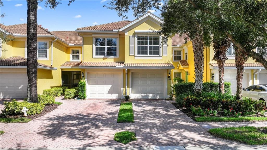 One or more photo(s) has been virtually staged, AI generated or rendered.  Enjoy spectacular lake and golf course views from this second-floor Cormorant coach home in the desirable 55+ Del Webb community of Ave Maria! Featuring soaring 12-foot-plus vaulted ceilings, an open-concept floor plan, and an abundance of natural light, this residence offers comfortable Florida living. The kitchen features stainless steel appliances, tile backsplash, ample cabinetry, pantry, and breakfast bar. Tile flooring extends throughout the main living areas, with carpeting in the bedrooms. The split-bedroom floor plan offers privacy for guests, while the spacious primary suite features dual sinks, a walk-in shower, and walk-in closet. Relax on the screened balcony overlooking the peaceful lake and golf course. Additional highlights include electric roll-down storm shutters, an attached one-car garage, and an in-residence washer and dryer. Conveniently located directly across from the neighborhood pool! **SOCIAL GOLF MEMBERSHIP INCLUDED!** Del Webb offers exceptional resort-style amenities, including the Oasis Club and Grand Hall, resort and lap pools, spa, fitness center, pickleball, tennis, bocce, golf simulator, billiards, dog park, community garden, on-site dining, and a full calendar of social activities. Golf enthusiasts will appreciate the championship Panther Run Golf Course. Residents also enjoy access to South Park and the many amenities of Ave Maria, including shopping, dining, parks, and walking and biking trails. Experience resort-style living with beautiful views and an unbeatable location!