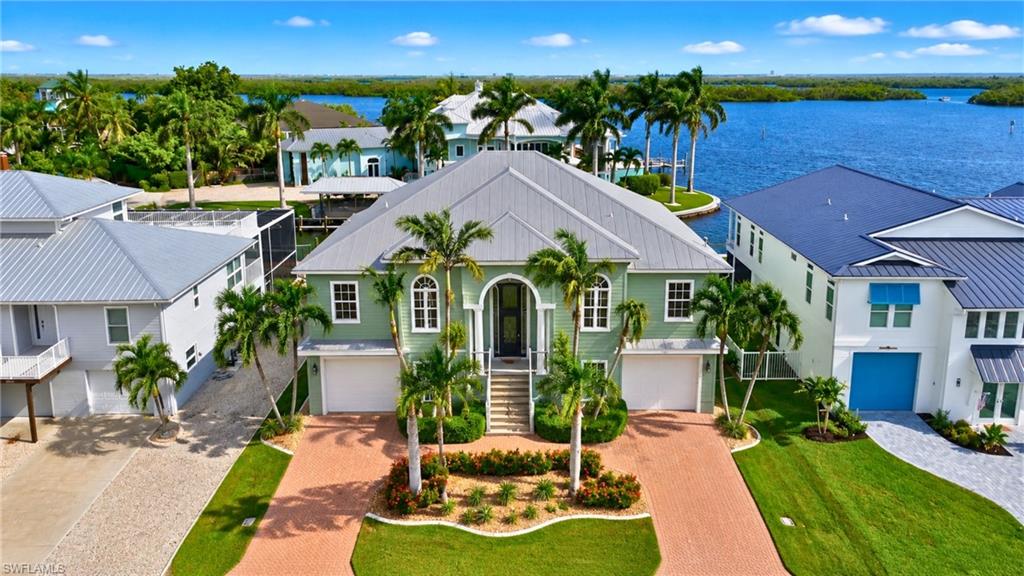 WATERFRONT PARADISE! Magnificent luxury custom-built home situated on a wide Gulf-access canal with direct access to picturesque Estero Bay. Built by Gary Lau, this exceptional residence offers approximately 2,600 sq. ft. under air, featuring 3 bedrooms plus a den, 3 luxurious bathrooms, and an abundance of ground-level open space ideal for storage, recreation, entertaining, and more.
An elevator provides effortless access to every level, blending convenience with sophisticated coastal living. The expansive great room features soaring ceilings and opens seamlessly to your private outdoor oasis. A spectacular two-story screened pool enclosure surrounds the inviting saltwater pool and spa, creating the perfect setting for relaxing, entertaining, and enjoying the year-round Florida lifestyle.
BOATER'S DREAM LOCATION! Step outside to your impressive 16,000-lb. boat lift and dock, where endless aquatic adventures await. With direct Gulf access, you can enjoy boating, fishing, sunset cruises, and easy access to the beautiful waters of Estero Bay and beyond. Wake up to tranquil waterfront views and spend your days exploring Southwest Florida by boat.
For the car enthusiast, boater, or outdoor lifestyle enthusiast, this property delivers with an oversized four-car garage, additional storage, and an RV electrical hookup. Every detail of this custom residence reflects quality craftsmanship, thoughtful design, and a commitment to luxury waterfront living.
Ideally located within walking distance to the marina, restaurants, bars, shops, and more, this home offers the perfect combination of privacy and convenience. Enjoy easy access to the south end of Fort Myers Beach via Lovers Key, with convenient boating and driving access toward Bonita Springs, Naples, and Southwest Florida's renowned dining and entertainment destinations.
From the lush surroundings and breathtaking water views to the resort-style pool, exceptional dockage, elevator, and generous garage space, this magnificent custom home offers an unparalleled waterfront lifestyle.
Experience the ultimate blend of luxury, comfort, boating, and waterfront bliss. Welcome home.