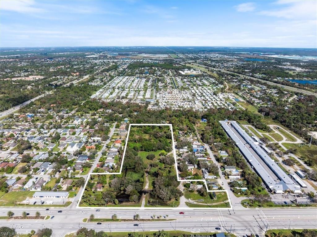 Bonita Boardwalk is a prime 8.4+/- acre development opportunity strategically located along the north side of Bonita Beach Road in Bonita Springs, Florida. Boasting approximately 635 feet of road frontage, this property enjoys excellent visibility and accessibility, positioned just east of Imperial Boulevard and west of I-75. The central portion of the site spans approximately 330 feet in width by 960 feet in depth, offering a substantial footprint of 316,800 square feet. Adjacent parcels provide additional flexibility: two to the east measure 170 feet wide by 115 feet deep (19,550 square feet), while three to the west measure 135 feet wide by 185 feet deep (24,975 square feet). The terrain is predominantly flat, with sections partially cleared, interspersed with mature trees that add natural charm. The northern area is heavily vegetated and falls within a FEMA Floodway. Zoning designations unlock diverse potential for development. The southern portion is zoned Interchange Commercial under the Bonita Beach Road Corridor Overlay, permitting up to 10 residential units per acre. Meanwhile, the northern section is designated Medium Density Residential, with a base density of 11.6 units per acre. Affordable housing density bonuses are not applicable in either zoning district, emphasizing the importance of thoughtful land use planning. This property offers a unique canvas for developers seeking to create a vibrant mixed-use community or a residential enclave. With its prime location, substantial lot size, and flexible zoning, Bonita Boardwalk is well-suited to meet the growing demand for thoughtfully designed developments in Bonita Springs.