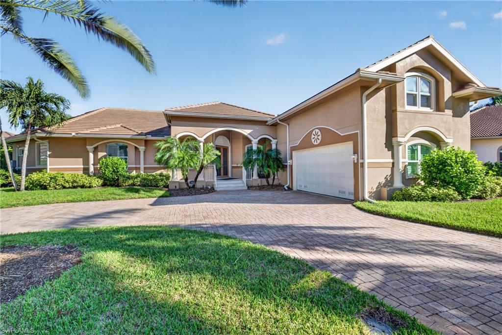 The boating lifestyle you've dreamed of, with a luxury home you never imagined! Welcome to Catalpa Cove, an exclusive gated enclave of distinctive custom homes where exceptional boating meets refined living. Your DEEDED FOR USE BOAT SLIP (#18) awaits on a deep-water channel offering quick, direct Gulf access just minutes from Sanibel Island! Complete with a 10,000-lb lift accommodating up to a 28' boat, water, electric, fish-cleaning station & storage, your gateway to paradise is ready when you are.

But here's the luxury few waterfront homes can offer: PRIVACY! Enjoy the best of both worlds—unrestricted boating adventures by day and peaceful evenings in your secluded backyard oasis, without passing boats, dockside noise, fuel odors or curious onlookers. This is coastal living, beautifully reimagined!

Beyond the pavered circular drive and elegant glass entry, discover a meticulously maintained custom residence where craftsmanship and thoughtful updates shine. Grand, open living spaces feature diagonal porcelain tile, tray ceilings, plantation shutters, graceful archways, built-ins and expansive sliders blending indoor and outdoor living. The spectacular kitchen is an entertainer's dream, showcasing custom glazed birch cabinetry with pullouts, gorgeous granite, an oversized gathering island, Wolf oven, induction cooktop and Sub-Zero refrigerator.

Retreat to the luxurious primary suite with bamboo flooring, custom walk-in closet, soaking tub and separate shower. Two additional bedrooms offer convenient ensuite and pool-bath access. Above the garage, a climate-controlled BONUS ROOM with half bath provides endless possibilities—fitness studio, game room, private retreat or creative space. Even the laundry room impresses with built-in cabinetry, storage and desk!

Outside, your PRIVATE RESORT awaits! An expansive pavered lanai offers multiple entertaining spaces, a heated pool with sun shelf, fountain and 7' deep end, outdoor kitchen, shower, fenced yard, lush privacy palms and orange trees. No waterfront traffic, no audience—just tranquility.

Exceptional upgrades include a 2023 TILE ROOF, 2024 IMPACT WINDOWS, whole-house GENERATOR with 500-gallon propane tank, hurricane shutters, whole-house water filtration, private irrigation well and an AIR-CONDITIONED GARAGE with epoxy floors and room for 2 cars, a golf cart and more! Elevated main living area with no reported flooding; transferable flood policy currently only $2,300/year. Community tennis adds to the lifestyle.

In a neighborhood where no two homes are alike, opportunities like this are exceptionally rare. Why choose between extraordinary boating and extraordinary privacy when you can have BOTH?