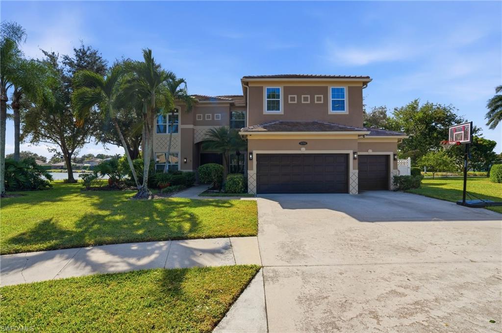 A home designed to impress, with room to live, entertain, and unwind. Welcome to this exceptional two-story residence in the coveted, gated community of Indigo Lakes, where more than 3,900 square feet of thoughtfully designed living space meets an oversized cul-de-sac homesite with tranquil lake views. Combining architectural elegance, everyday comfort, and remarkable versatility, this home offers a distinctive Southwest Florida lifestyle. A tile roof, replaced in 2024, and lush tropical landscaping create an impressive first impression, while impact windows installed in 2022 provide added peace of mind. Inside, soaring ceilings, elevated door heights, designer trim, tray ceilings, and luxury vinyl plank flooring enhance the home's spacious, light-filled interiors. The thoughtfully designed floor plan features four bedrooms, a first-floor den with an adjacent full bathroom, formal living and family rooms, and an elegant dining room highlighted by a coffered ceiling and modern chandelier. At the heart of the home, the beautifully appointed kitchen features custom cabinetry, quartz countertops, a center island, subway tile backsplash, stainless steel appliances, under-cabinet lighting, and a generous walk-in pantry. A convenient first-floor laundry room offers a utility sink, cabinetry, and additional storage. Throughout the residence, thoughtfully placed linen closets, an under-stair storage closet, and abundant additional storage provide exceptional organization and functionality. The spacious primary suite offers a tray ceiling, tranquil water views, and a beautifully appointed bath featuring stone tile surrounds, a luxurious soaking tub, glass-enclosed shower, and towel warmer. A custom-designed walk-in closet provides exceptional organization. An unexpected highlight awaits off the primary suite—a private screened terrace overlooking the lake, offering a peaceful setting for morning coffee, evening sunsets, or simply unwinding while taking in the tranquil water views. An additional bonus room, currently utilized as a fitness area with built-in shelving, offers endless possibilities as a media room, playroom, hobby space, or additional retreat. Designed to embrace Southwest Florida's indoor-outdoor lifestyle, the expansive screened lanai features a sparkling saltwater pool, covered gazebo, and peaceful lake views, creating an inviting setting for entertaining or quiet relaxation. Ideally located near shopping, dining, beaches, and everyday conveniences, this exceptional Indigo Lakes residence offers the perfect balance of generous living spaces, flexible functionality, refined details, and the Florida lifestyle.