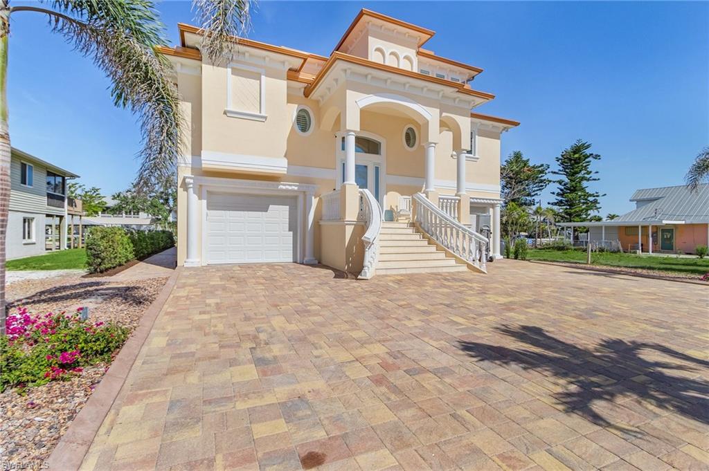 Welcome to 161 Egret Street, Fort Myers Beach, FL, a boater’s paradise and a stunning example of coastal living at its finest. Built in 2016 and extensively improved within the past three years, this beautifully maintained, fully furnished home offers the perfect blend of luxury, comfort, and turnkey convenience. Located on a quiet cul-de-sac with direct Gulf access, the property features a covered boat lift and upgraded heavy-duty lift system, along with a lighted dock, making it ideal for those looking to explore Southwest Florida’s pristine waterways. The beach is a short walk or a quick Golf Cart ride away, enhancing the island living experience.  Inside, the thoughtfully designed floor plan features 4 bedrooms and 3.5 bathrooms, offering generous space for the entire family and their guests. High-end finishes, 10-foot ceilings, impact-resistant windows and doors, and an elevator enhance the home’s livability and comfort. Recent upgrades include a brand-new metal roof, new pool heater and pump, new A/C compressors, new water heaters, freshly updated landscaping with a new sprinkler system, and a thermal steam shower in the primary bath. The gourmet kitchen is fully equipped and ideal for entertaining. At the same time, the spacious living areas flow seamlessly to a private outdoor retreat with a fire pit, heated pool, and spa, creating an inviting environment for year-round enjoyment. Additional conveniences include dual two-car-length garages, providing ample storage for vehicles, toys, and boating equipment. Offered fully stocked and move-in ready, 161 Egret Street is truly a turnkey escape, just bring your toothbrush. With an unbeatable location minutes from the beach and local attractions, every comfort in place, and thoughtful upgrades throughout, this home delivers the ultimate Fort Myers Beach lifestyle.