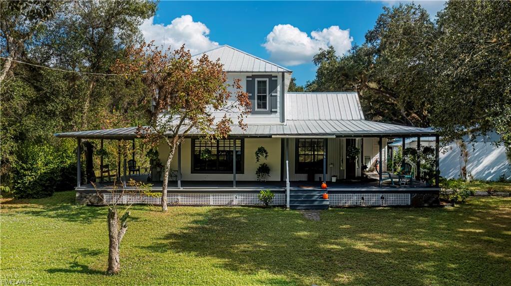 Take a look at this beautiful, oak filled, lot located in the heart of LaBelle. This almost 1 acre property contains mature oaks along with native trees giving a peaceful outdoor setting. The charming 2 story home was built in 1912 and since has had many renovations including newer metal roof, updated electric/light fixtures, new hot water heater, new vinyl flooring in the foyer/kitchen area, and new carpet in the living room. There is a detached efficiency apartment/mother-in-law suite which could be used by quests or used as a rental. The storage sheds and out buildings give you plenty of space for all of your tools, lawn equipment, etc. Enjoy entertaining at family gatherings under the covered patio, with outdoor sink/counter-top and a fire pit area. The wrap around porch is great for watching the beautiful Florida sunset. This is truly a must see, one of a kind property!