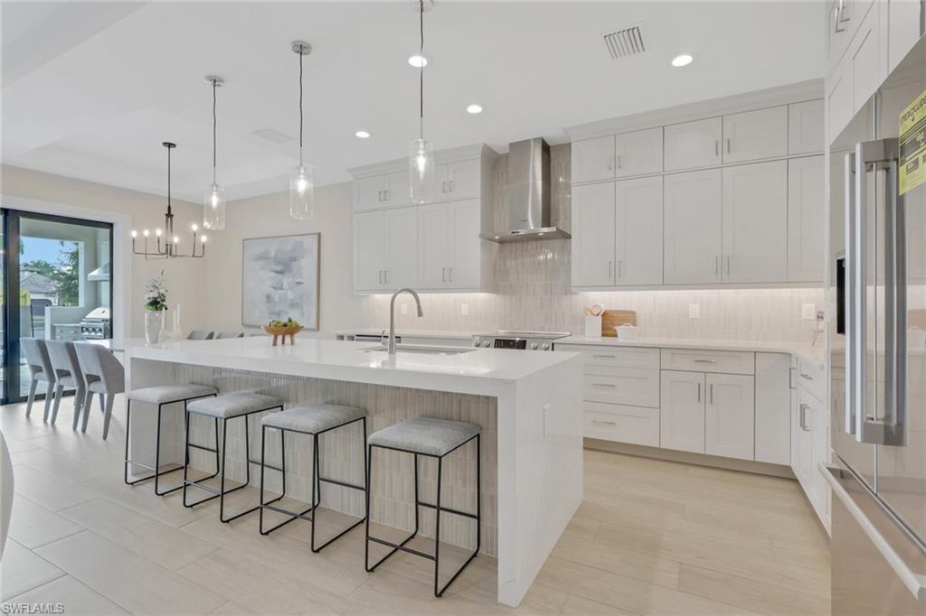 Wow what a show stopper this home is, 5 bedrooms, 3 bathrooms with an open floor concept. Brand new new construction home recently built end 2025. Be stunned by this well appointed floor plan using the sqft available wisely and not waste any space. Over 11 foot high ceilings throughout welcome you as soon as you enter into the home and lead throughout the entire space. Enjoy entertaining and cooking in your gourmet Kitchen with center island, stainless steel Bosch appliance package including glass slide in range, french door refrigerator, stainless vent hood, built in microwave and white painted cabinets with upgraded quartz counter tops, decorative wainscoting and Tile backsplash. Spacious main bedroom leads into your luxurious ensuite bathroom with double vanity, oversized shower with handheld shower 96" tall frameless shower enclosure, white painted shaker cabinets with quartz tops, upgraded wall tile, linen closet, huge walk-in closet. Spacious open floor living room features 14' pocket sliding glass doors going out to your lanai. Upgraded trim package including 7" baseboards throughout. Your laundry room is equipped with front load washer and dryer with countertop above for folding station and painted shaker style cabinets. Additional recessed cans with LED lights throughout the home. Wall mount TV's in all rooms as well as Lanai. The Exterior offers a concrete tile roof as well as Impact resistant doors and windows throughout for hurricane safety. Upgraded landscape, irrigation and sod package with Fenced in side and rear yard, Brick paver drives and walks are some of the additional upgrades this home will have. The ultimate Florida entertainment oasis will be created with your Pool and spa package and outdoor kitchen has your backyard summer times secured. Make this dream home your reality today. Located in desirable North Naples. This wellappointed pool home is west of US 41 and is within a short distance to Delnor Wiggins State Park and Vanderbilt Beach. You can enjoy all the amenities of North Naples including dining, shopping and movies at The Mercato. NO HOA and no rental restrictions!!!! Pictures are of a similar home recently finished