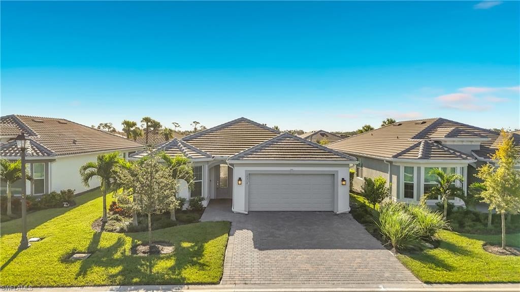 One or more photo(s) has been virtually staged, AI generated or rendered.  Welcome to Del Webb Oak Creek, a gated, resort-style 55+ community.  This Pulte-designed residence offers the rare opportunity to enjoy a refined lifestyle without the wait of new construction. Occupied for only four months, the distinguished Mystique floor plan of 1922 sq ft is thoughtfully designed living space with 2 Bedrooms and a Den, which could also be a 3rd bedroom.  This adaptable layout accommodates your lifestyle today while allowing it to evolve with your needs.
The heart of the home is a gourmet kitchen appointed with the upgraded KitchenAid appliance package, thoughtfully designed for both everyday living and elegant entertaining. Natural gas adds a further touch of culinary sophistication and efficiency.
Expansive 180-degree sliding glass doors dissolve the boundary between the interior and the outdoors, opening the living area fully to the lanai. There, automatic privacy blinds allow you to tailor the setting at the touch of a button, creating a serene retreat for quiet mornings or evening gatherings.
A three-car tandem garage with air conditioning provides generous space for vehicles, a golf cart, or additional storage. Seamless gutters are already in place, and the homesite is fenceable, offering flexibility for pets, privacy, or future enhancements.
Life at Oak Creek is defined by its setting of tranquil lakes and natural preserves and its exceptional array of amenities. Residents enjoy a grand clubhouse with a fitness center and movement studio, a resort-style pool and spa, pickleball and bocce courts, a fire pit lounge, and the Oak House Bar & Grill with tiki seating, all complemented by a full-time lifestyle director.
Every detail of this residence reflects quality, comfort, and an effortless Southwest Florida lifestyle. We invite you to arrange a private showing and experience it for yourself.